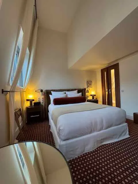 Hotel Bed and Amber Lamps — Quiet Interior Calm