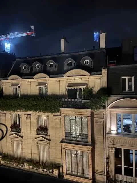 Paris Rooftops at Night — Warm Windows and Slate Lines
