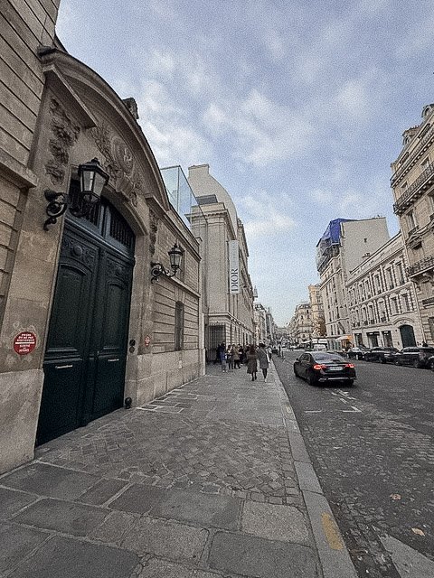 Parisian stone façades and muted street textures captured in calm afternoon light.