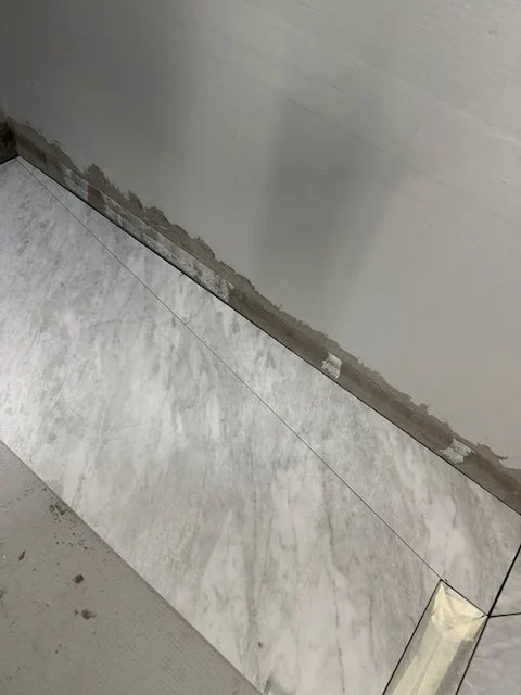 Bathroom floor edge preparation before re-tiling