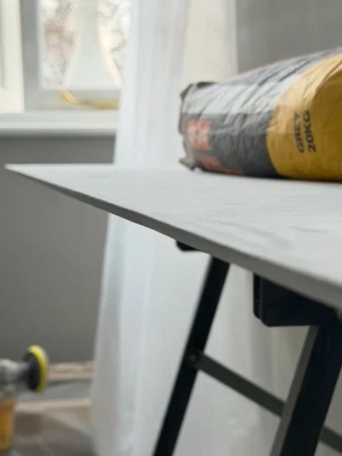 Bathroom tile preparation on workbench in natural light