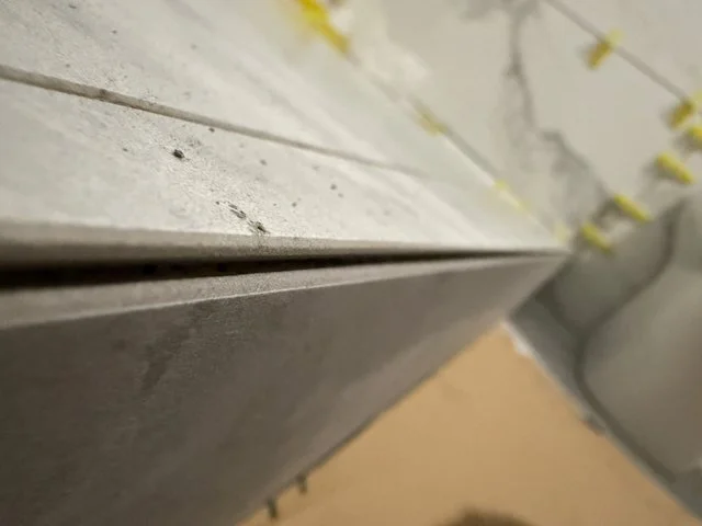Mitre-cut tile edge detail during bathroom installation