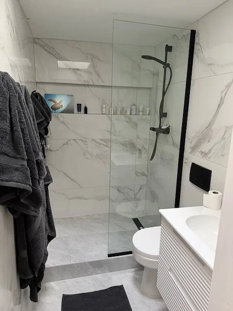 Final bathroom interior with glass shower and vanity