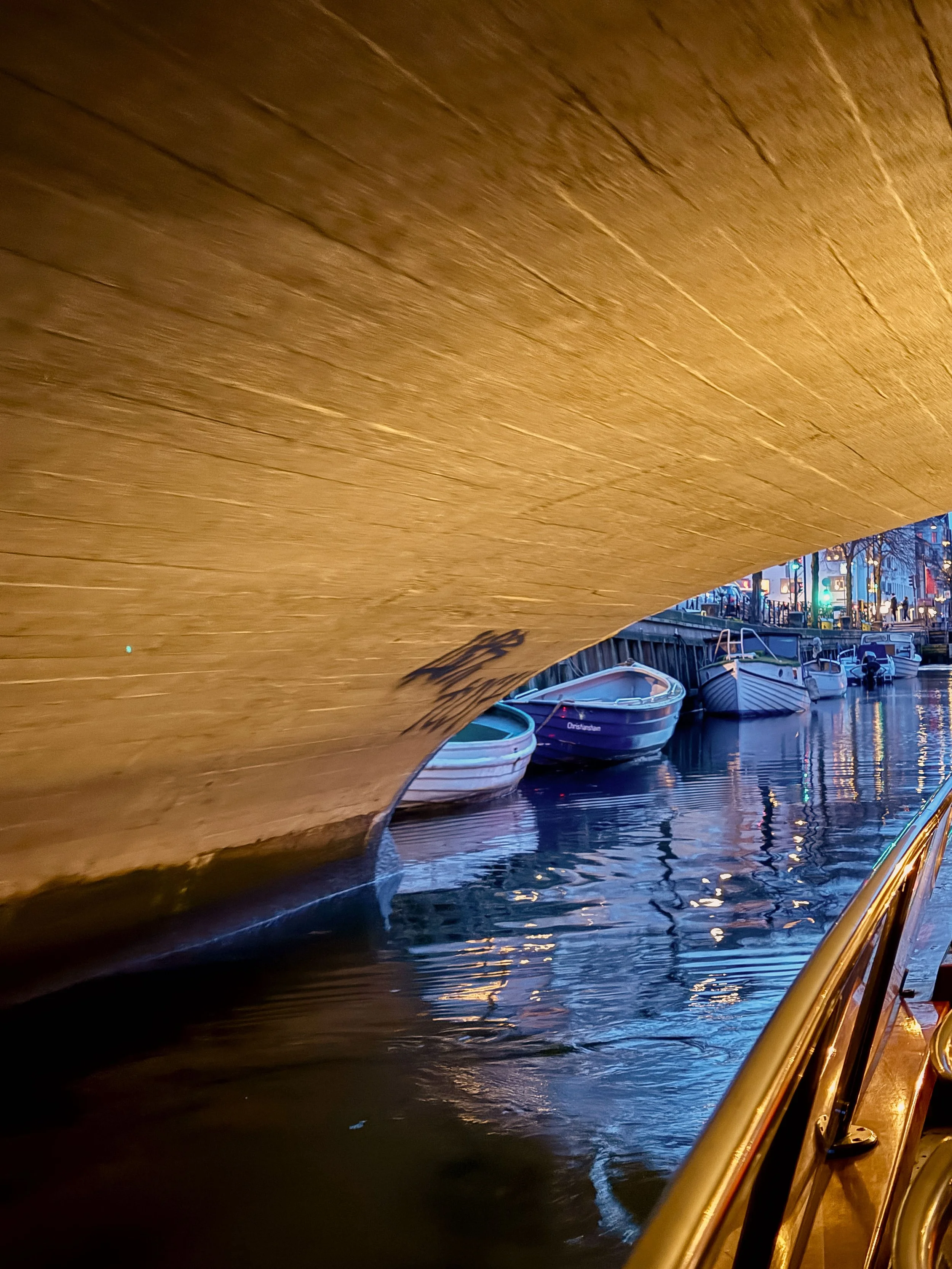 Canal Reflections Beneath a Bridge in Copenhagen