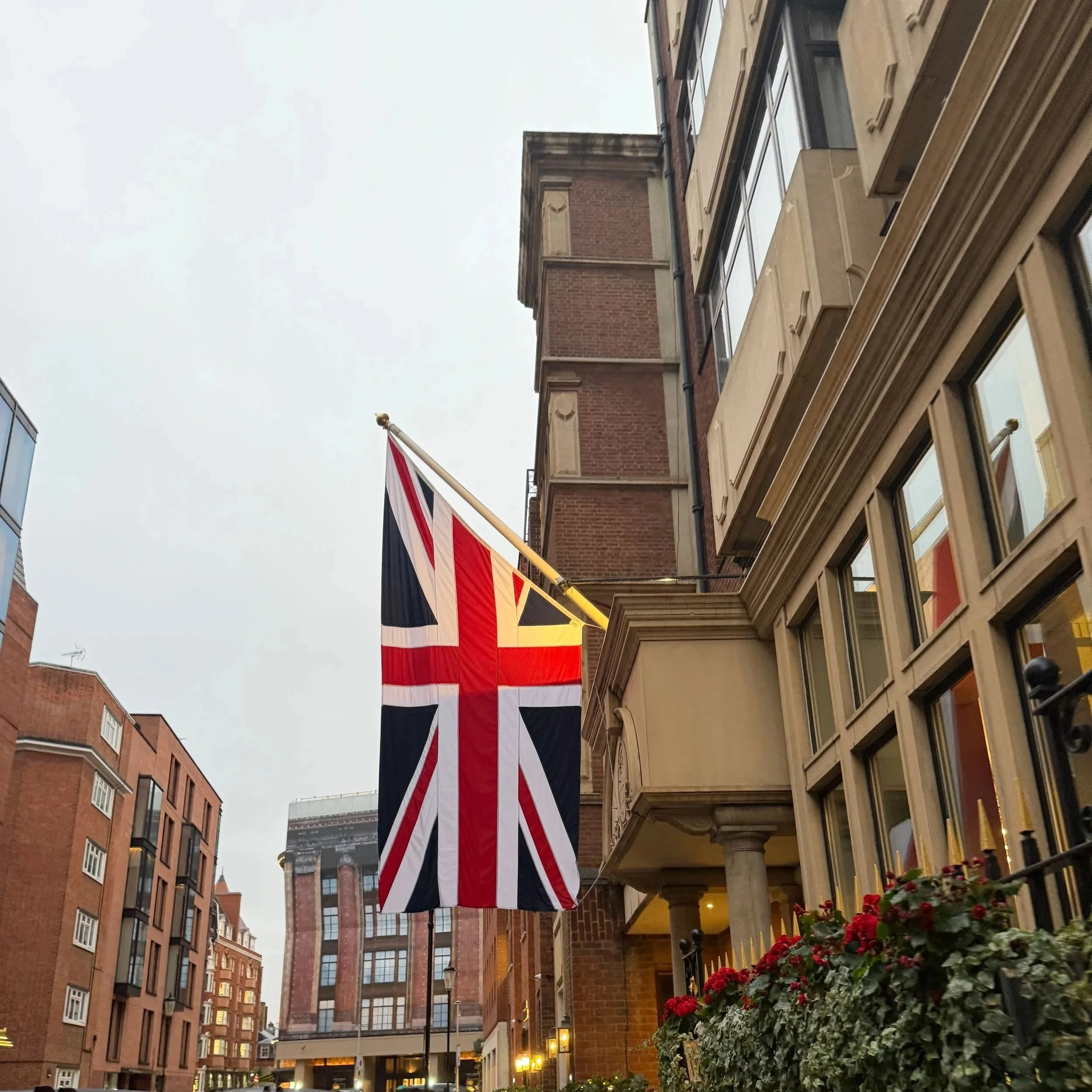A Union Jack caught in winter light — red brick, soft skies, and London’s quiet architectural rhythm.