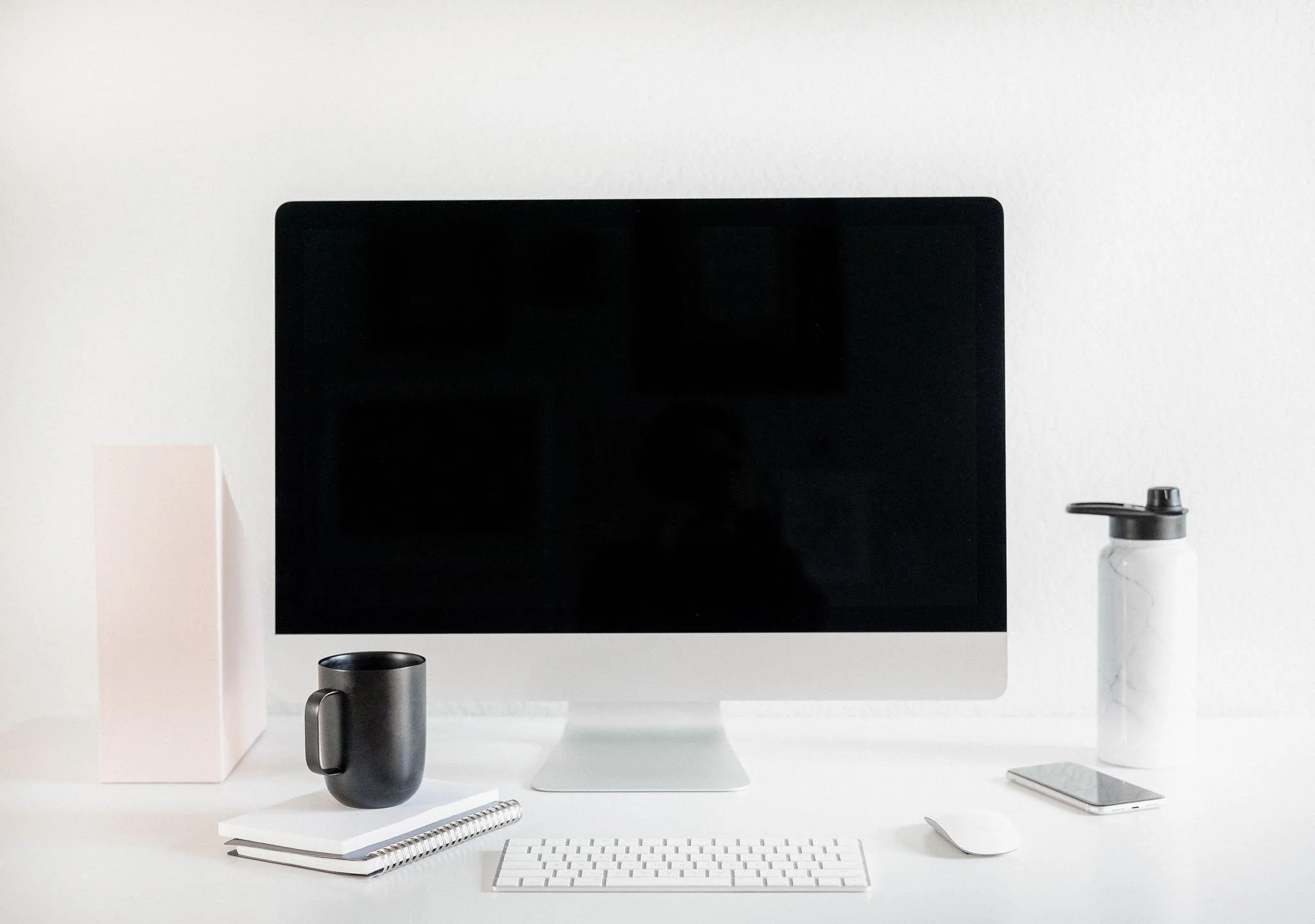 Minimal white desk workspace with laptop, coffee and open space supporting focus and easy transitions.