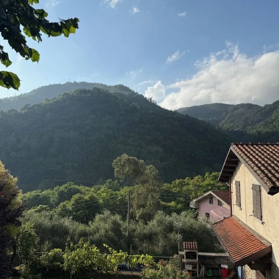 House on a Tuscan Valley looking out over green mountains
