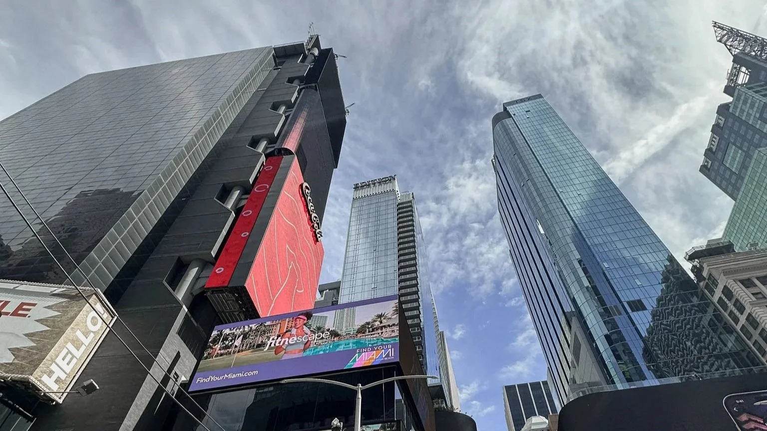 Looking up at New York skyscrapers in winter, showing vertical architecture and dense city scale against a cold sky.