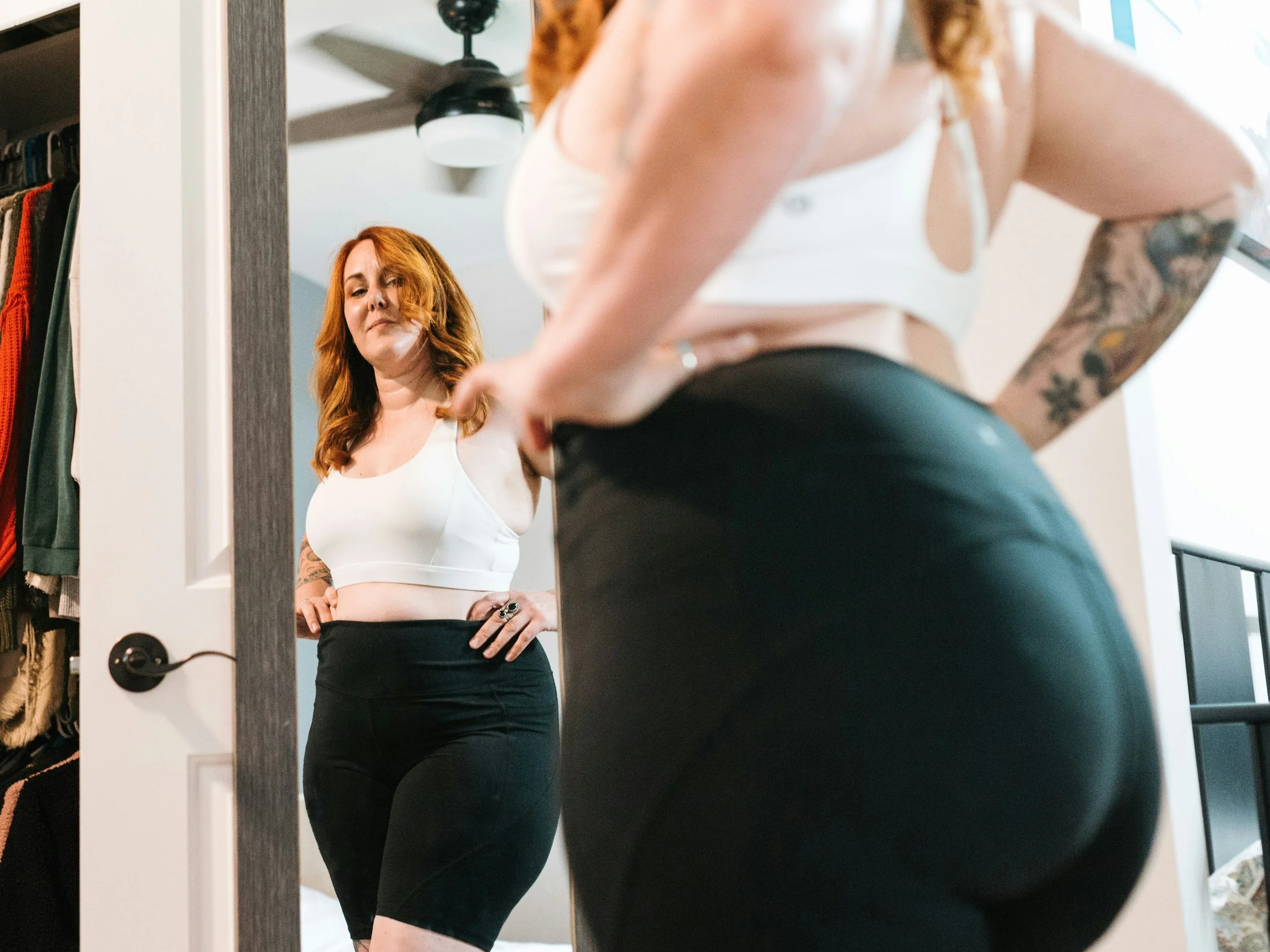 Plus size woman looking in the mirror