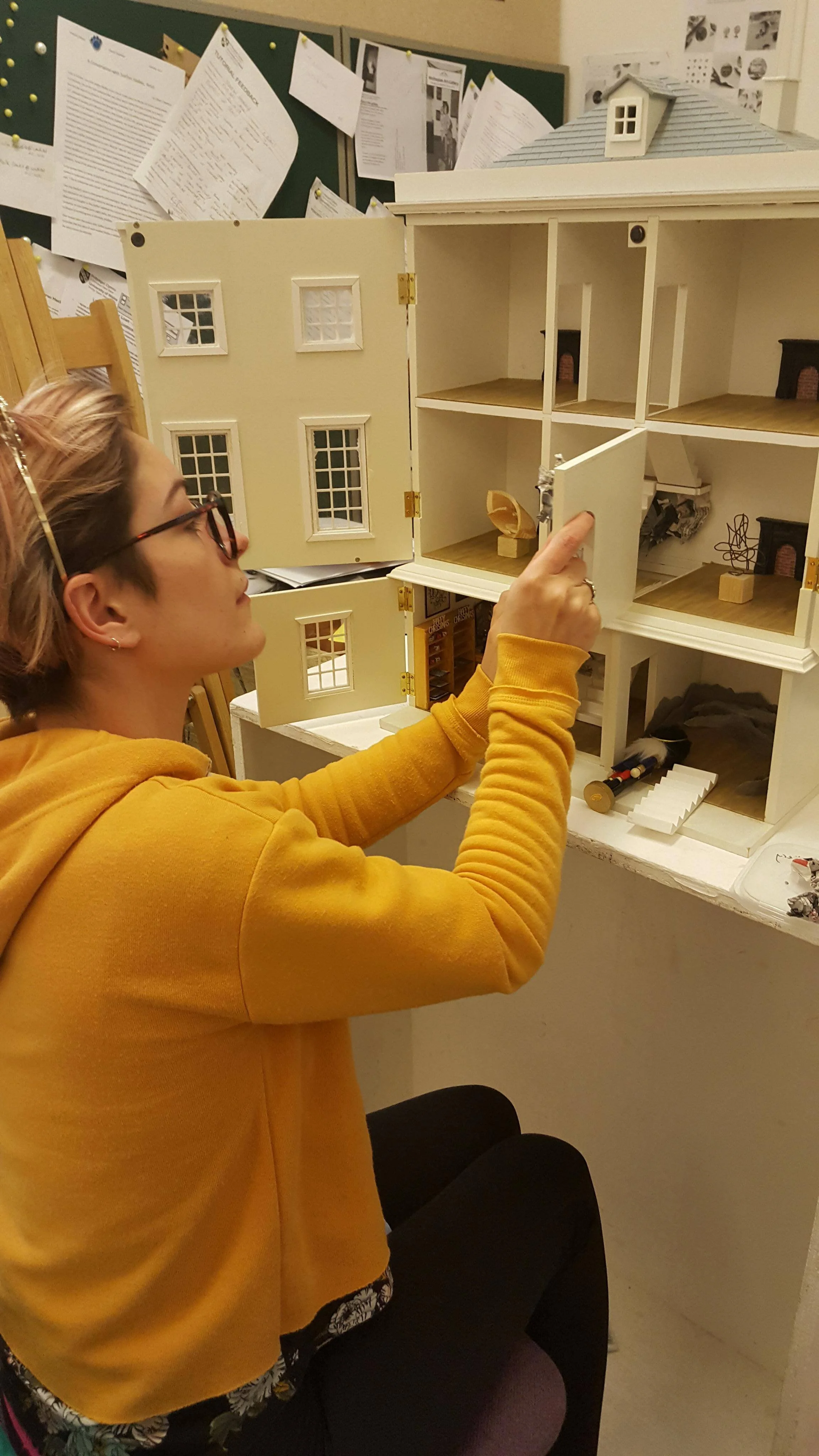 Emily Scandone setting up her miniature versions within the gallery. (2017)