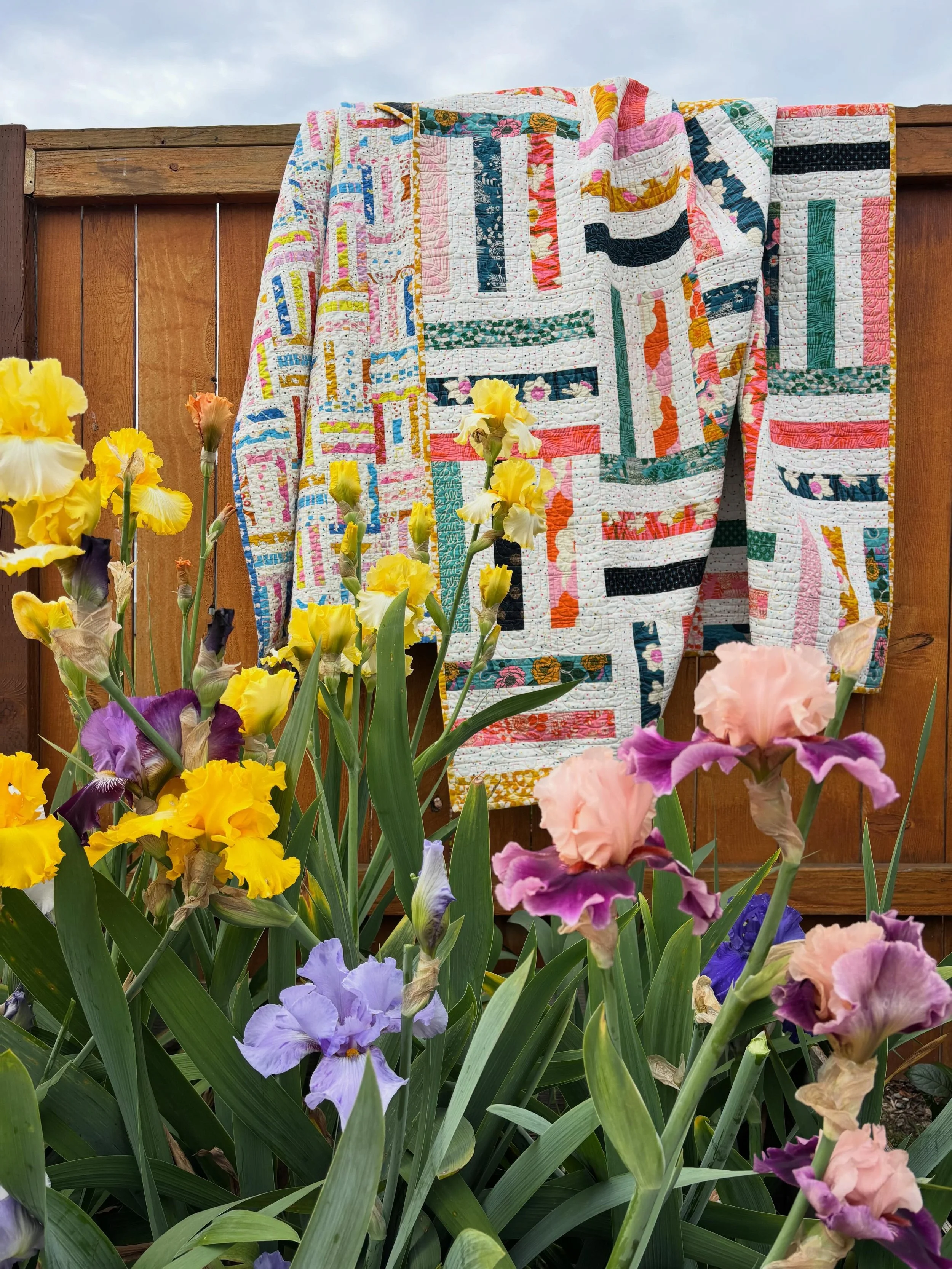 shoutout to the real star of this photo - my hubby - who balanced on the garden beds and fence, to hang the quilts for this photo. 💛

Quilts: Joyful Stripes and Joyful Stripes 2.0