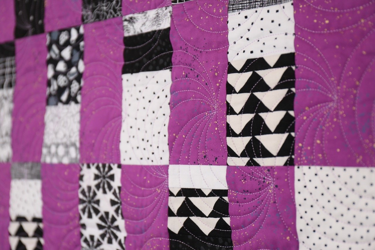 Majestic Scraps is a beginner quilt pattern. Make it in a baby or throw size. This pattern is a scrappy, fat quarter, and yardage friendly quilt pattern. Black & White Quilt.
