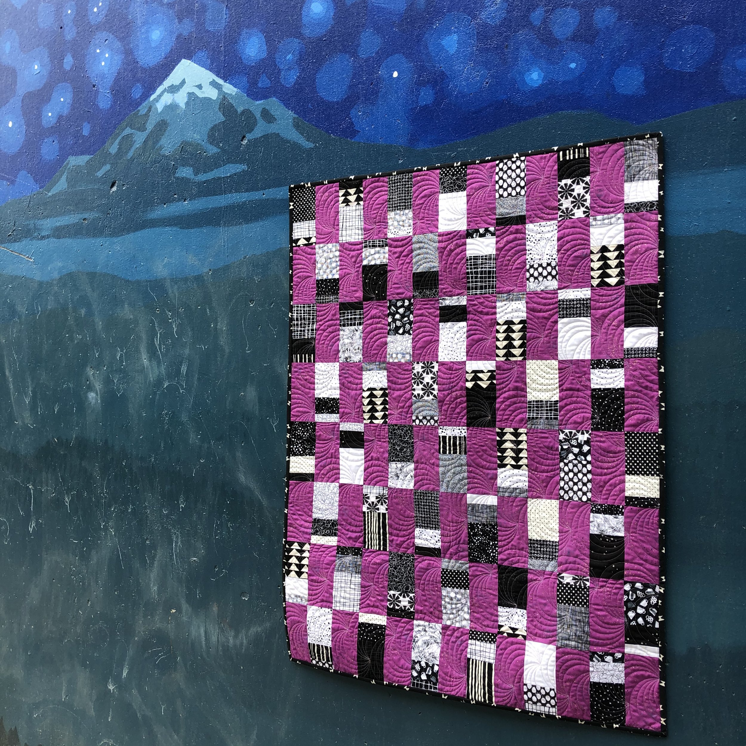 Majestic Scraps is a beginner quilt pattern. Make it in a baby or throw size. This pattern is a scrappy, fat quarter, and yardage friendly quilt pattern. Black & White Quilt.