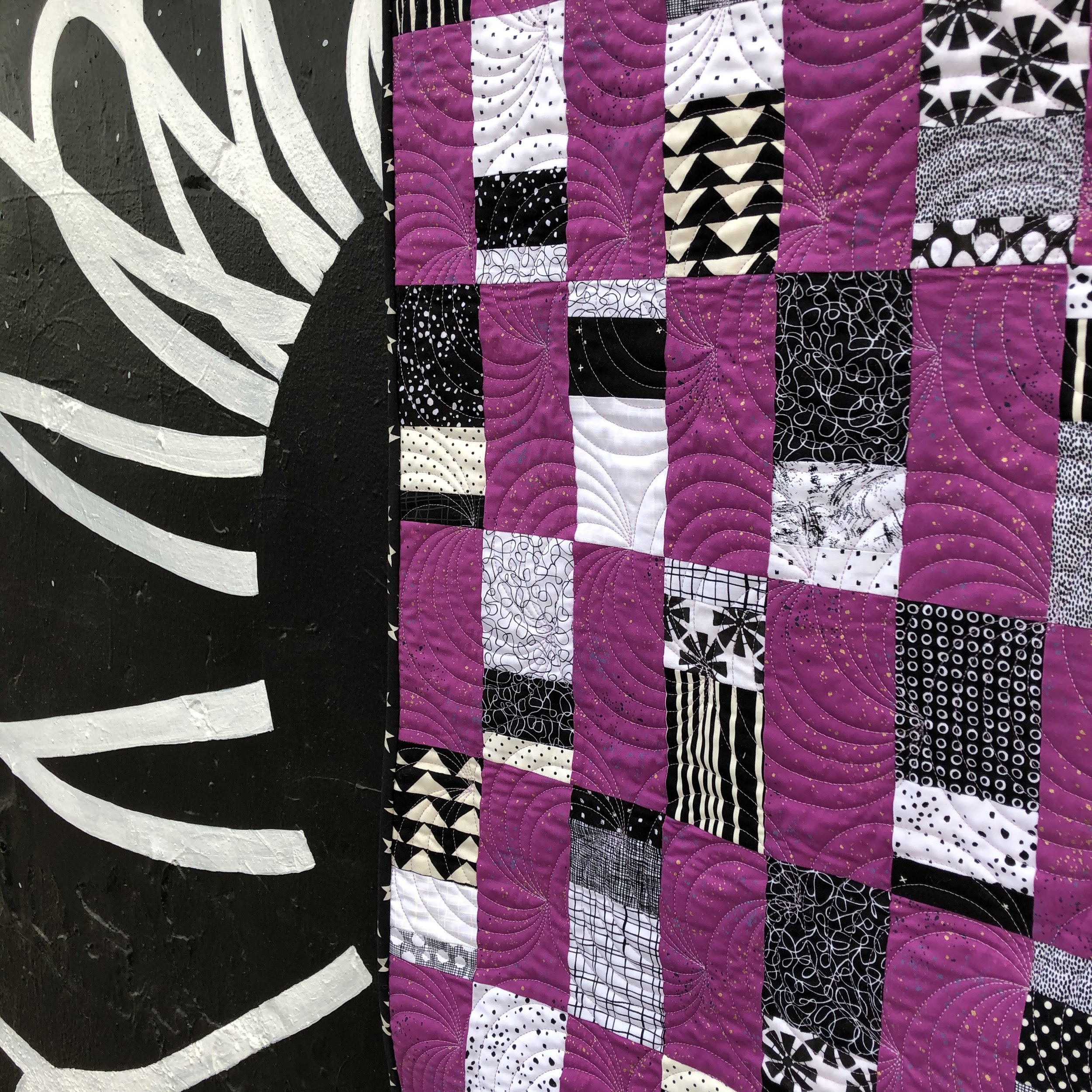 Majestic Scraps is a beginner quilt pattern. Make it in a baby or throw size. This pattern is a scrappy, fat quarter, and yardage friendly quilt pattern. Black & White Quilt.