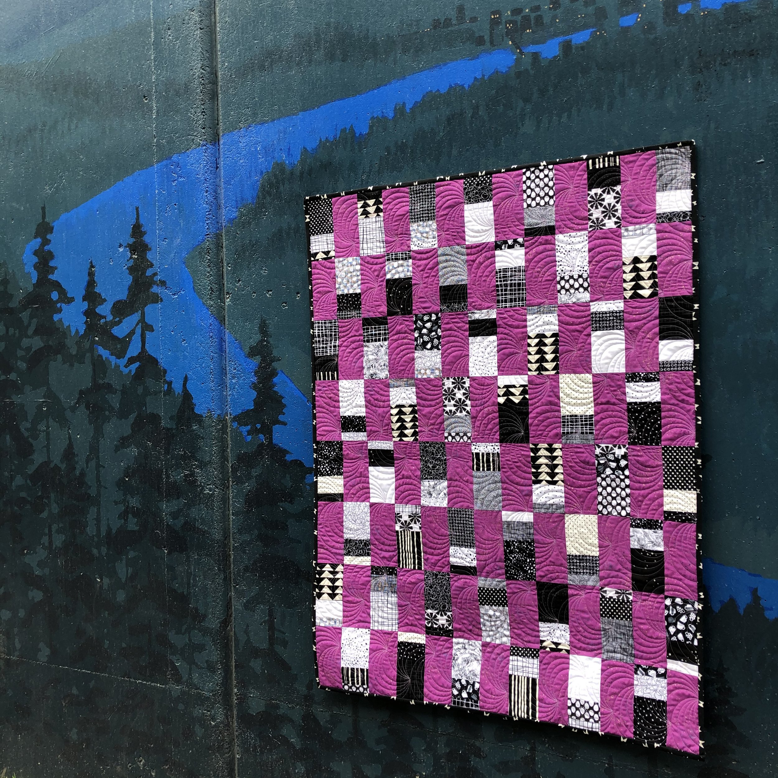 Majestic Scraps is a beginner quilt pattern. Make it in a baby or throw size. This pattern is a scrappy, fat quarter, and yardage friendly quilt pattern. Black & White Quilt.