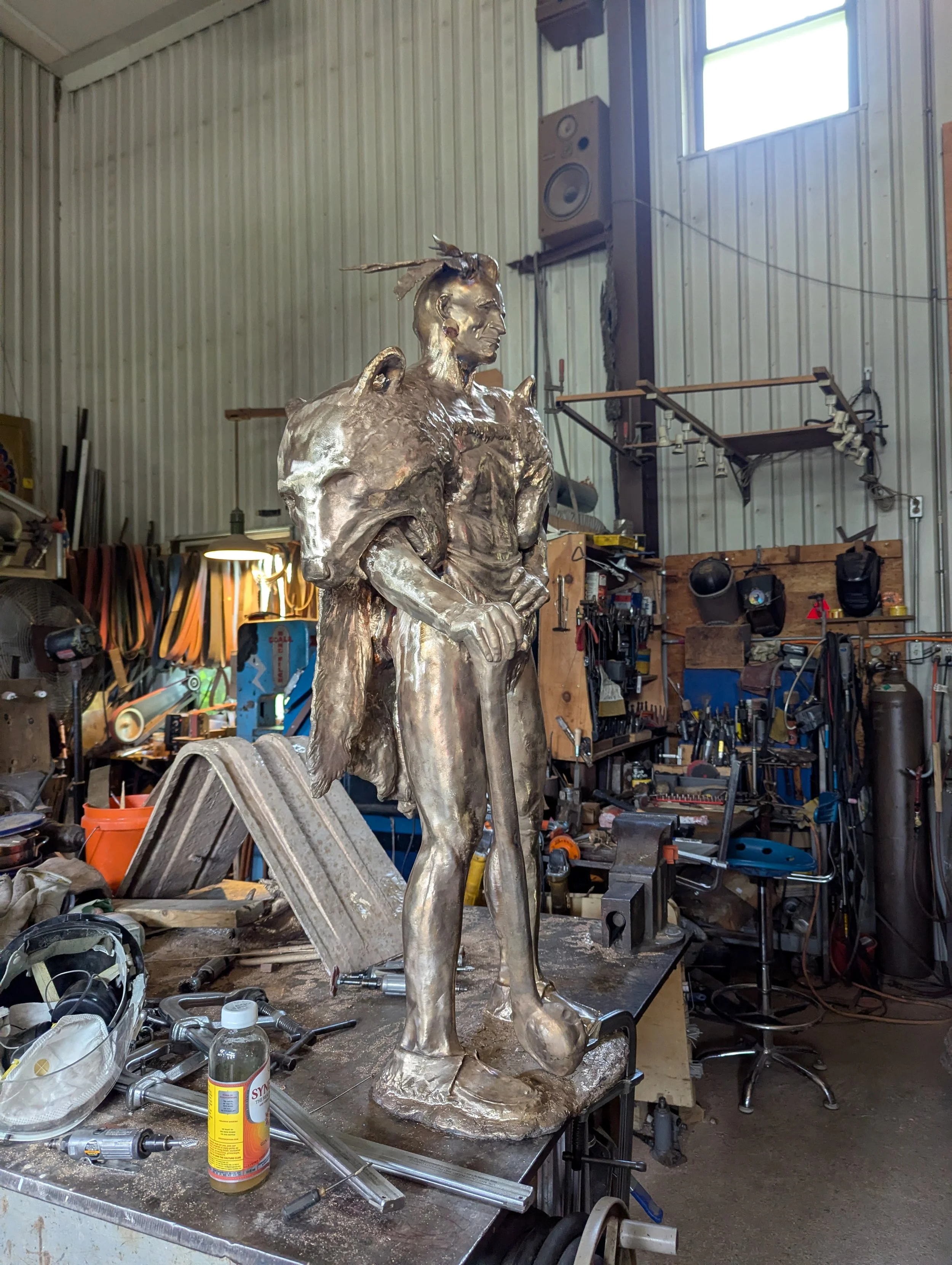 Bronze figure in the workshop — the sculptural form translated into metal.