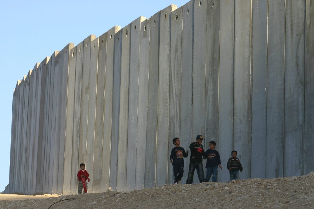 Palestinian-children-playing-near-a-high-wall-that-separates-their-residence-wih-Israeli-settlements.-e1512217406539.jpg