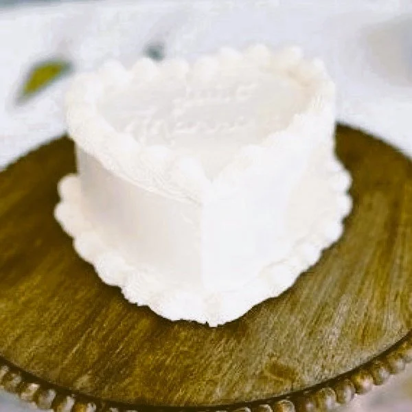 A small delicate heart-shaped wedding cake