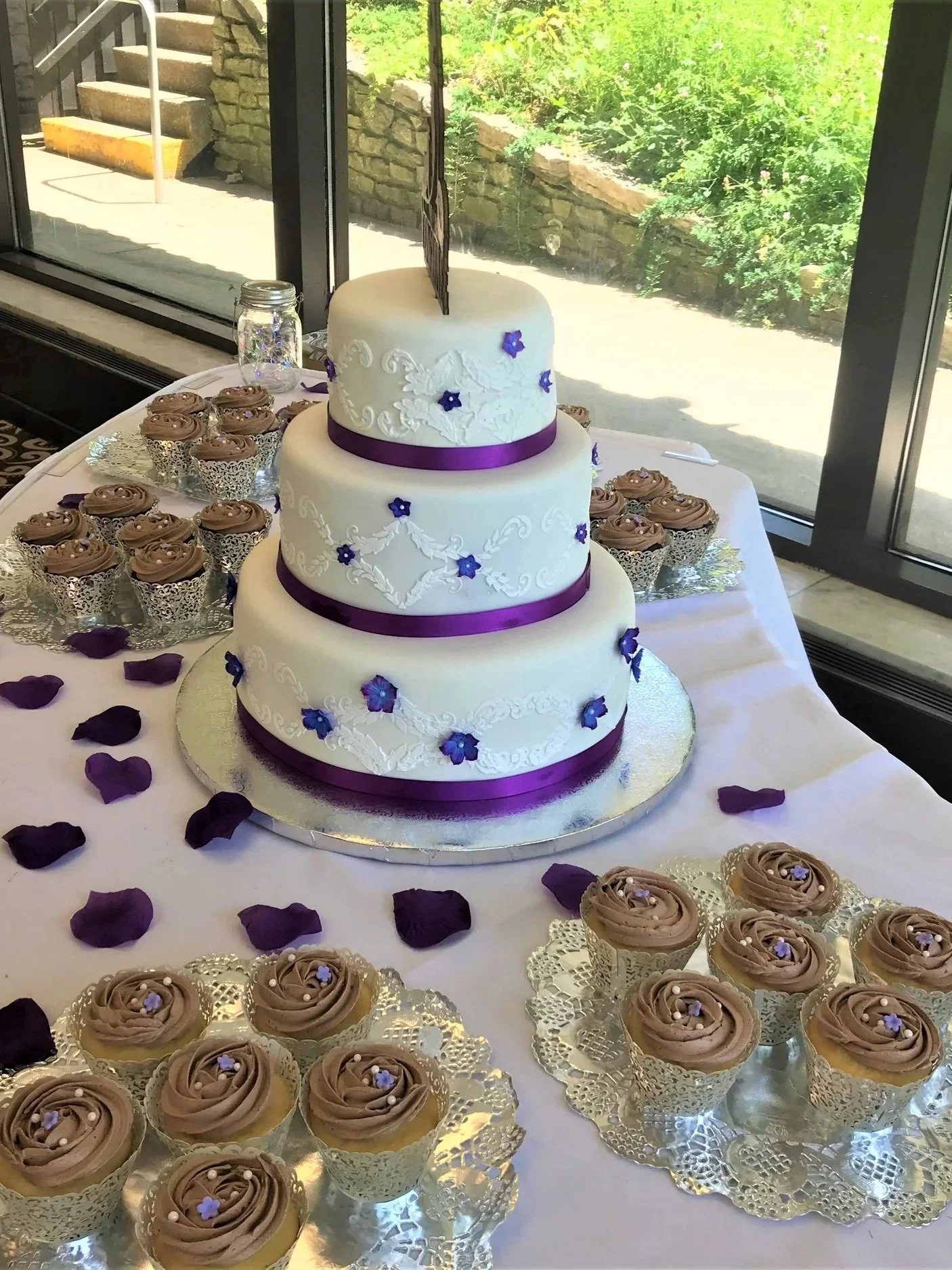A three tiered elegant vintage styled cake with delicate floral accents