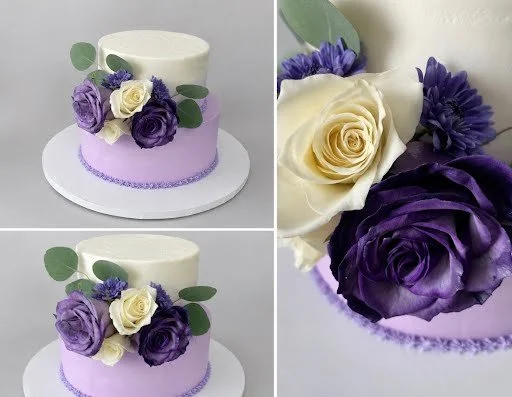 Two-tier lavender and ivory wedding cake with fresh roses and eucalyptus created by Artsy Cakeworks in Lancaster, Ohio.