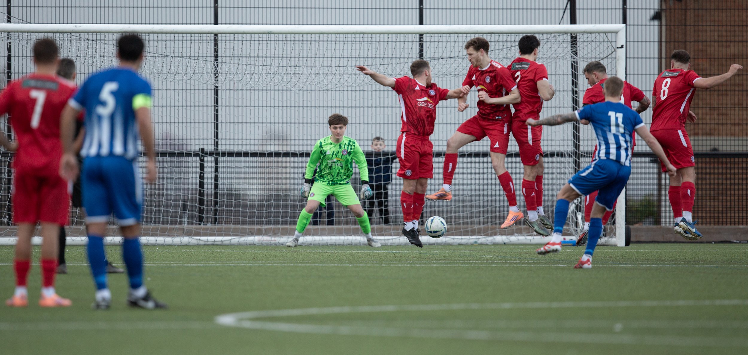 Whitley Bay score from a freekick hammering the ball under the wall and past the diving keeper.