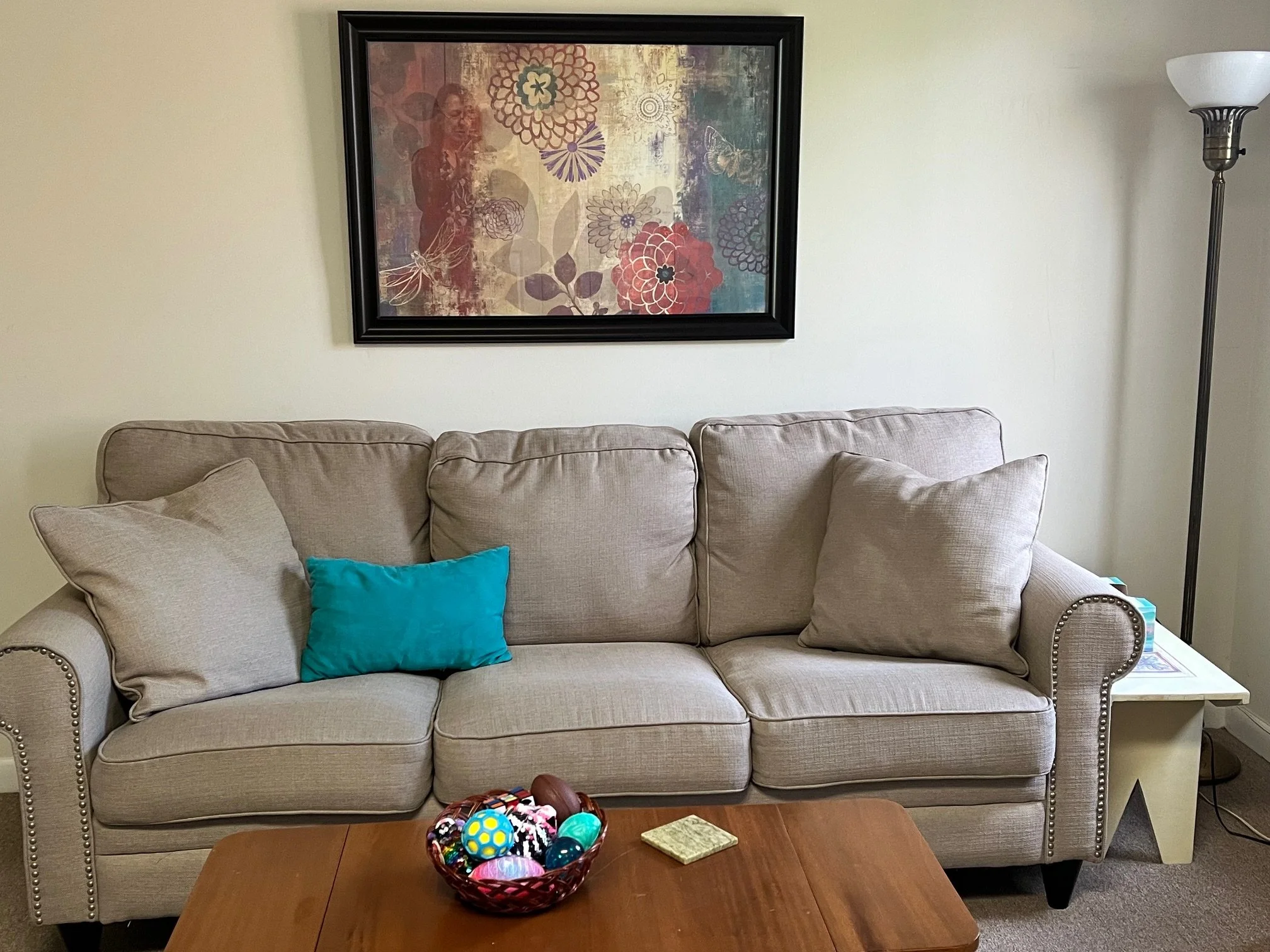 Comfortable large sofa to accommodate family members with a basket full of sensory toys easily accessible!
