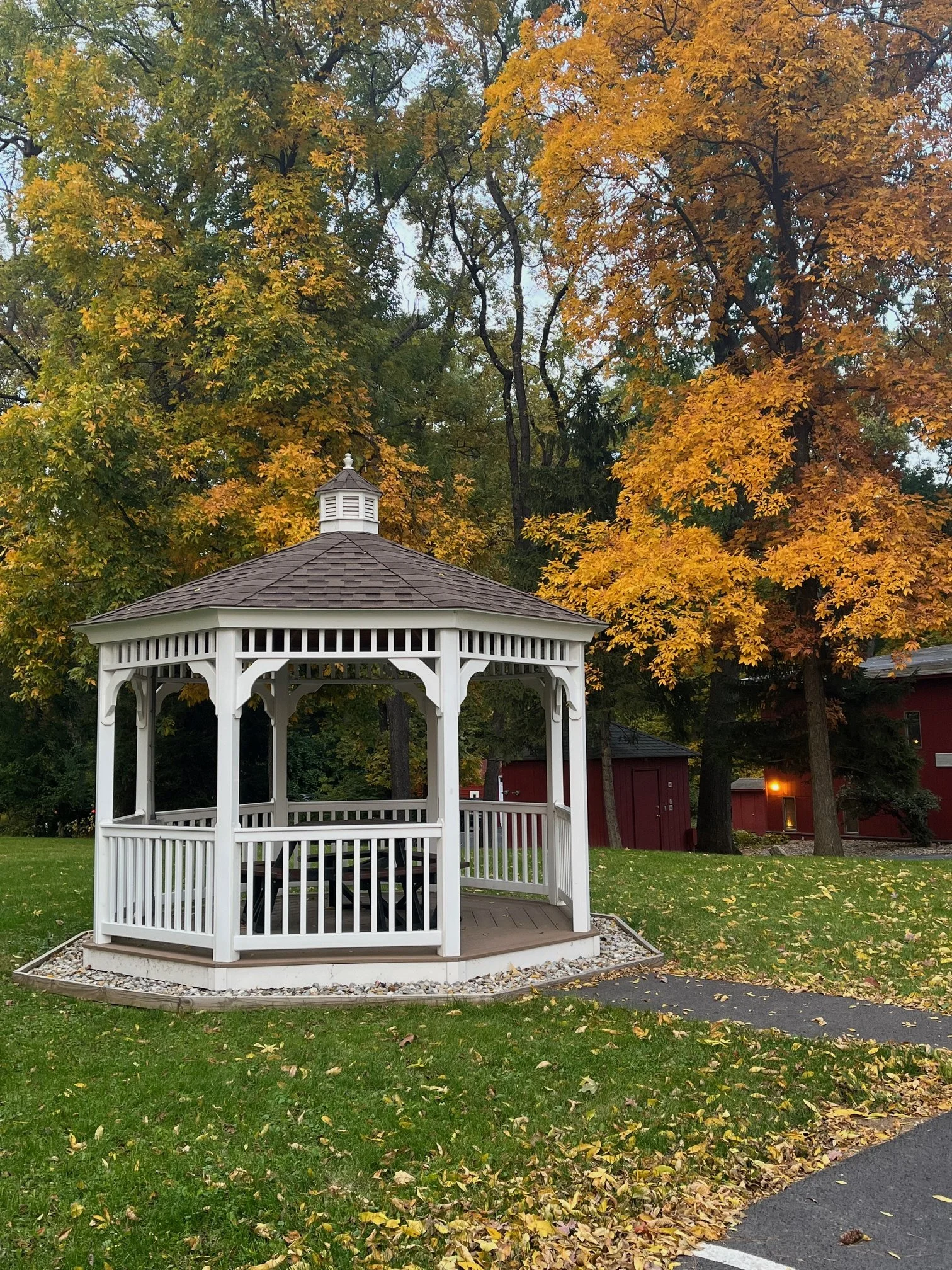 View from office includes a white gazebo surrounded by green space and mature trees. Plenty of free parking is available next to office building.