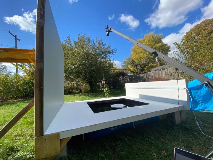Mock gallery wall rotated to face sky. A hole is cut from the center and inserted is a reflecting pool, sculpture, and sundial. This set is used to create paintings and photographs and is not for exhibition purposes.