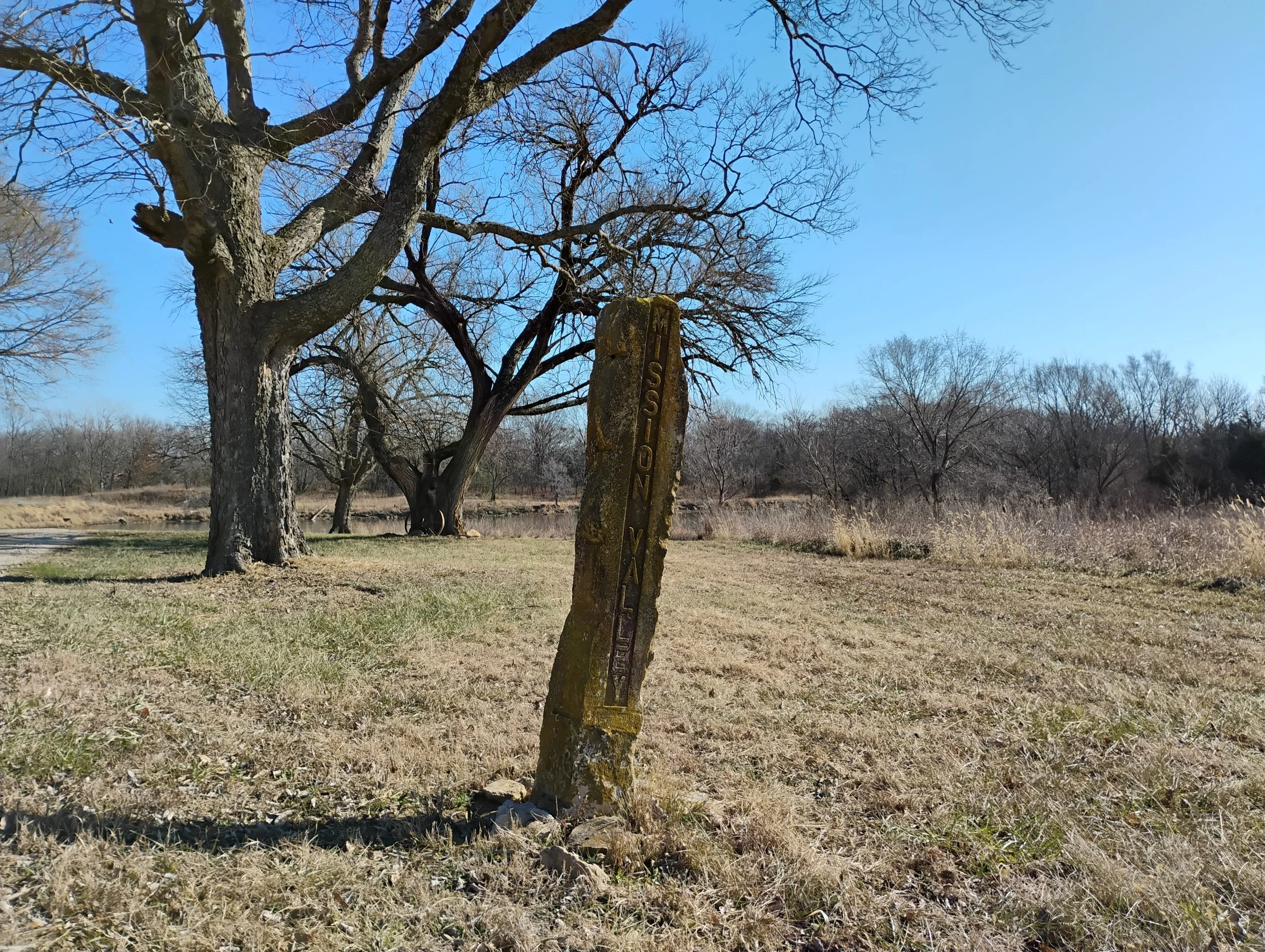 Old stone sign with the name of the local high school. 