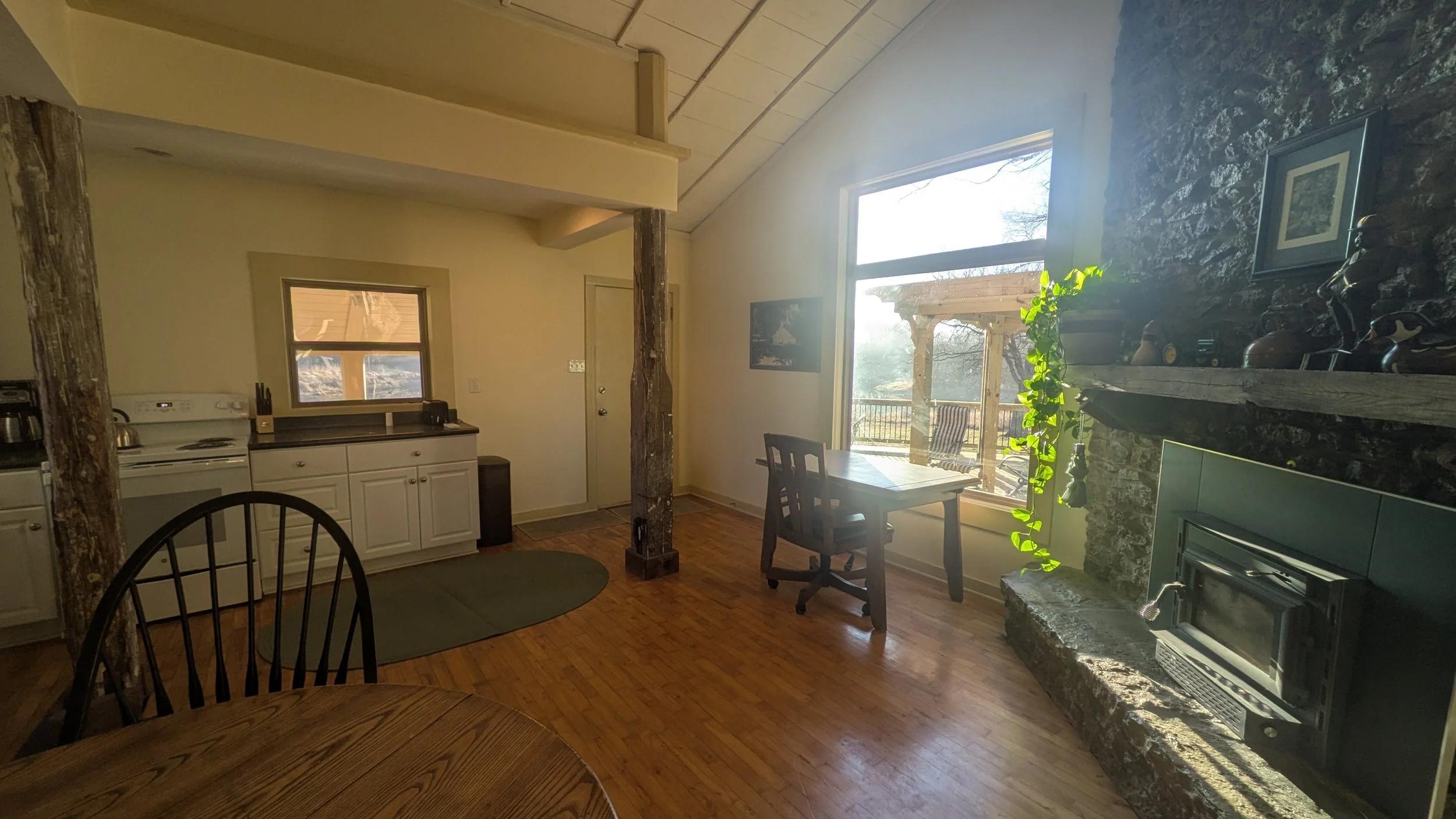View of the front door, countertop, and fireplace facing the front entrance.