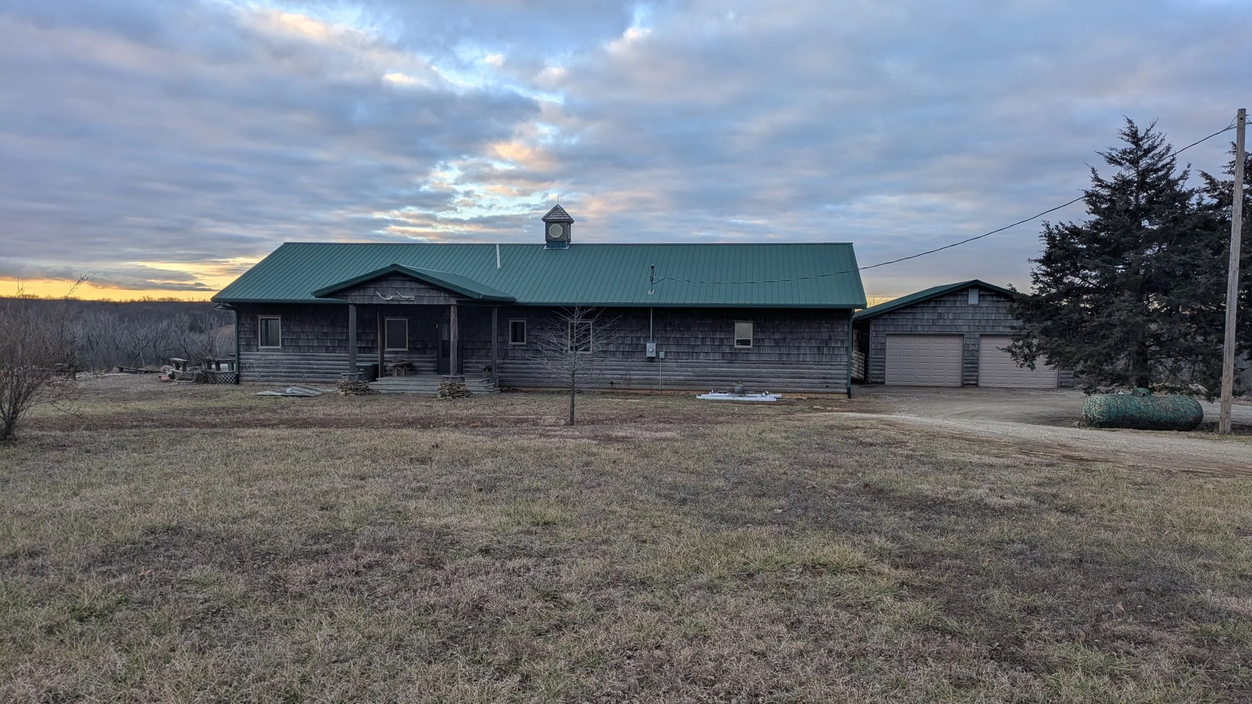 Spacious front facing view of the house and detached garage.