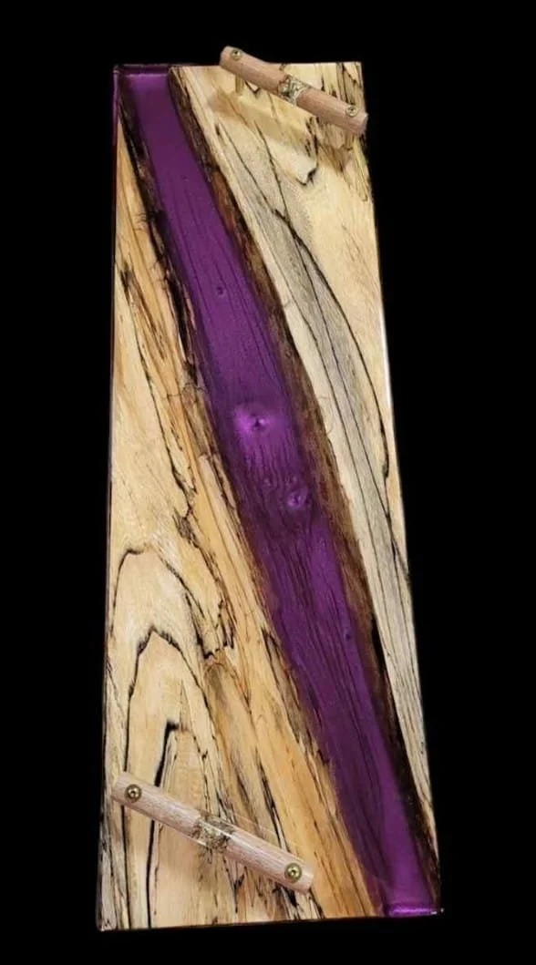 A finished piece of wood with a purple streak running through it.