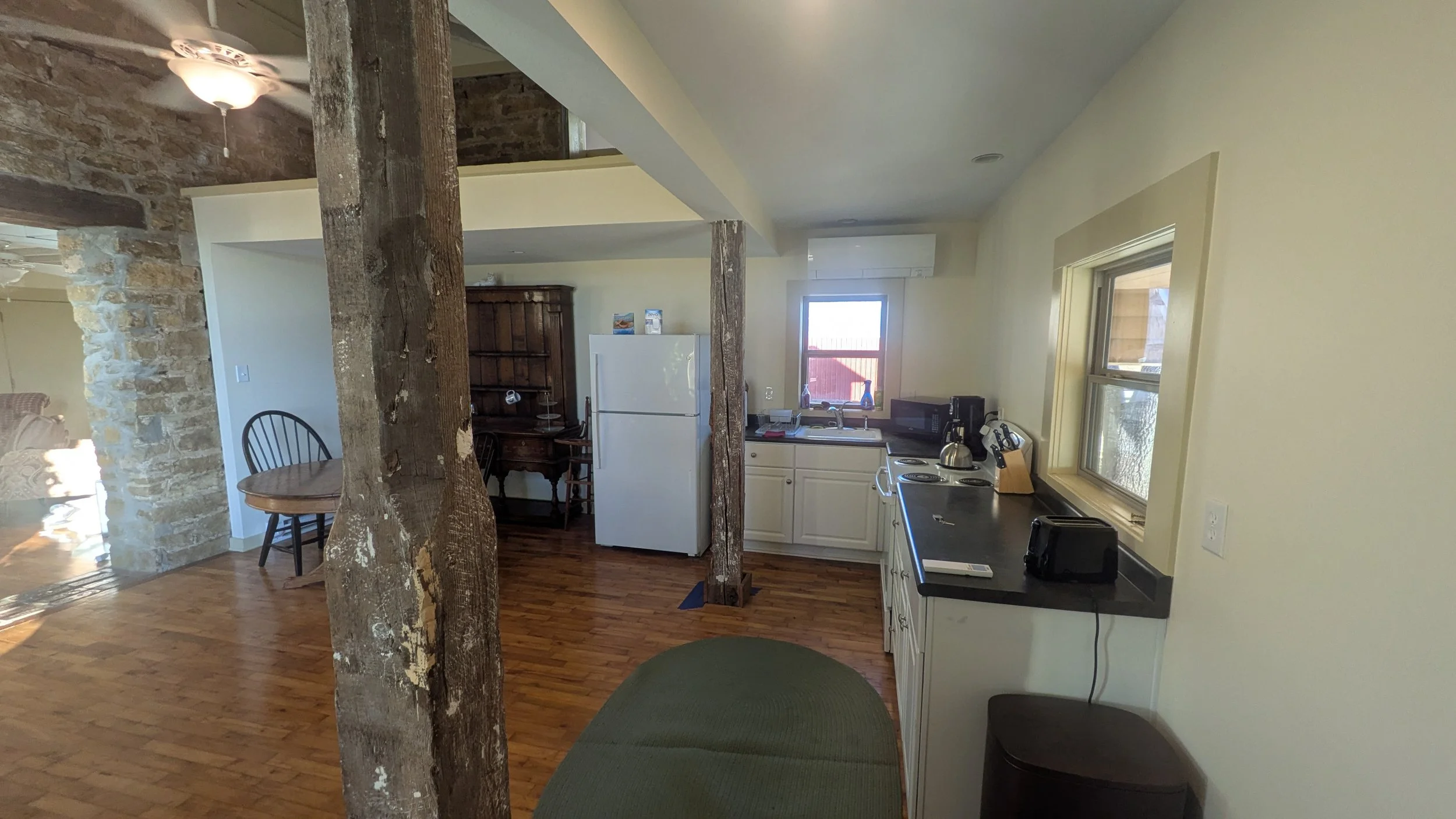 POV of the front door entrance facing the kitchen appliances.