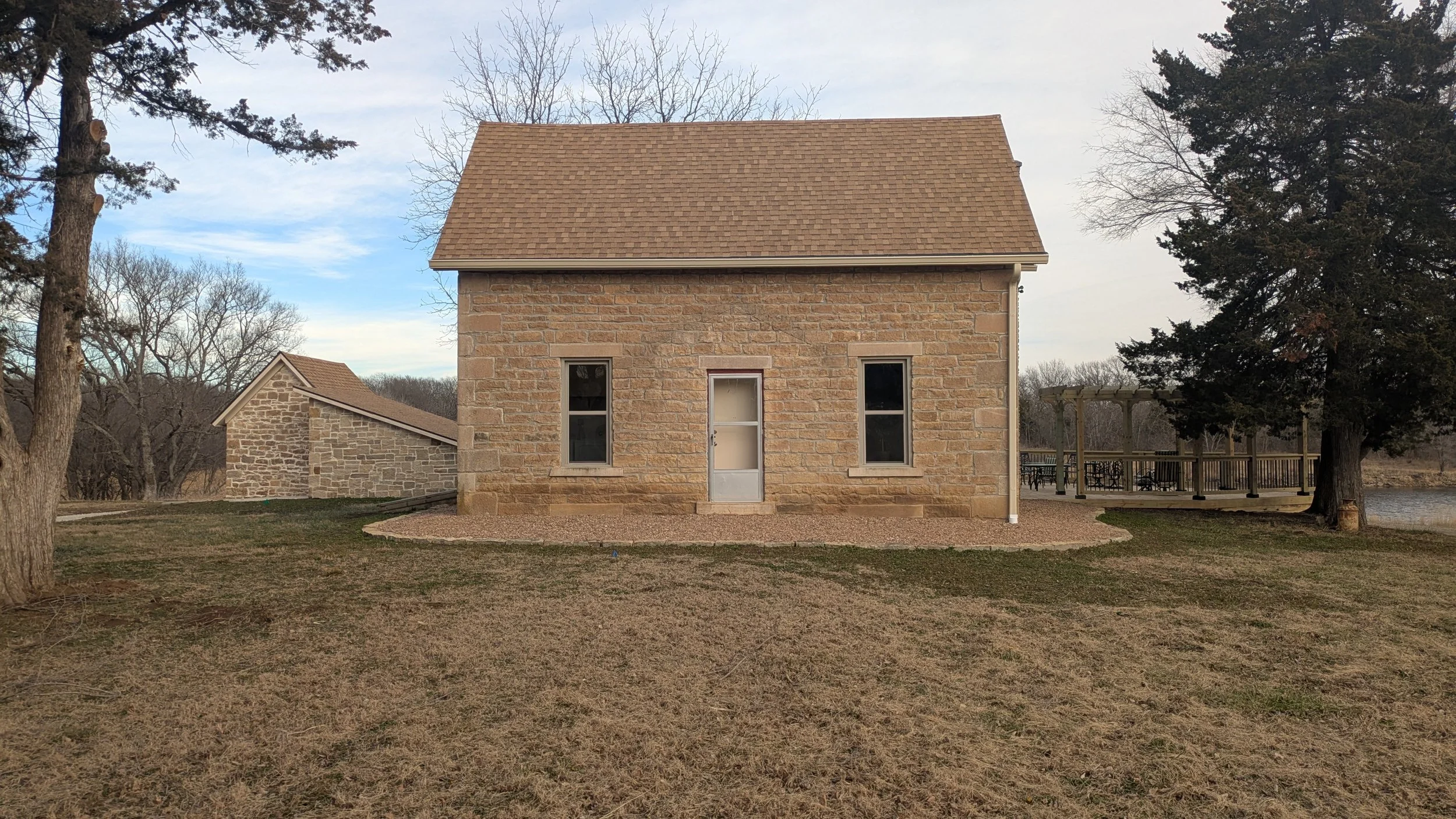 Front facing view of the Limestone portion of the houses with a view of the smoke house to the left.