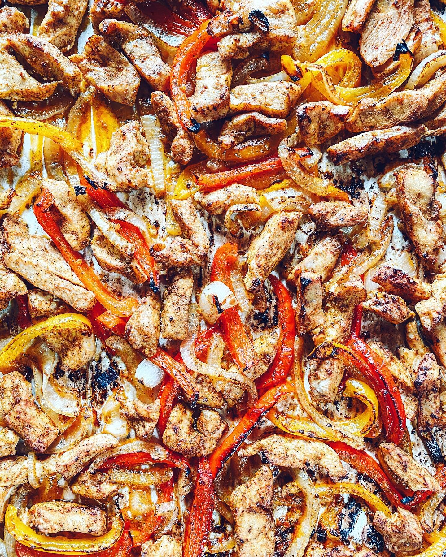 These sheet pan chicken fajitas are a new family fave. To make them, thinly slice bell peppers, onions and boneless/skinless chicken breasts or thighs (3 peppers, 2 onions, 1.5 lbs chicken), toss with a generous glug or three of olive oil, a few tabl