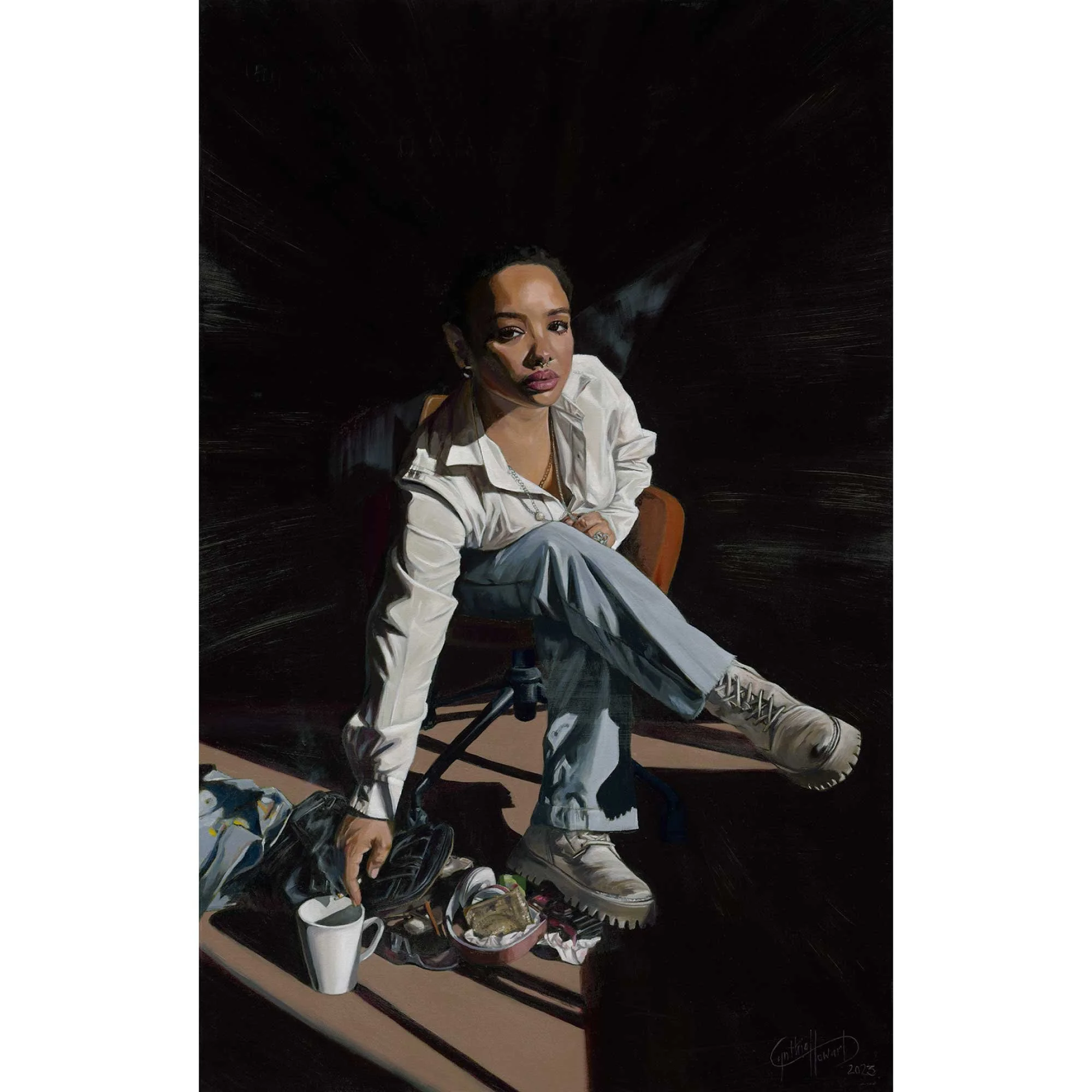 Portrait of actor Sisi Stringer. A figure wearing a white shirt, blue pants and combat style boots sits cross legged on a brown chair. She holds a cigarette over a coffee cup. The floor is a maze of her belongings.