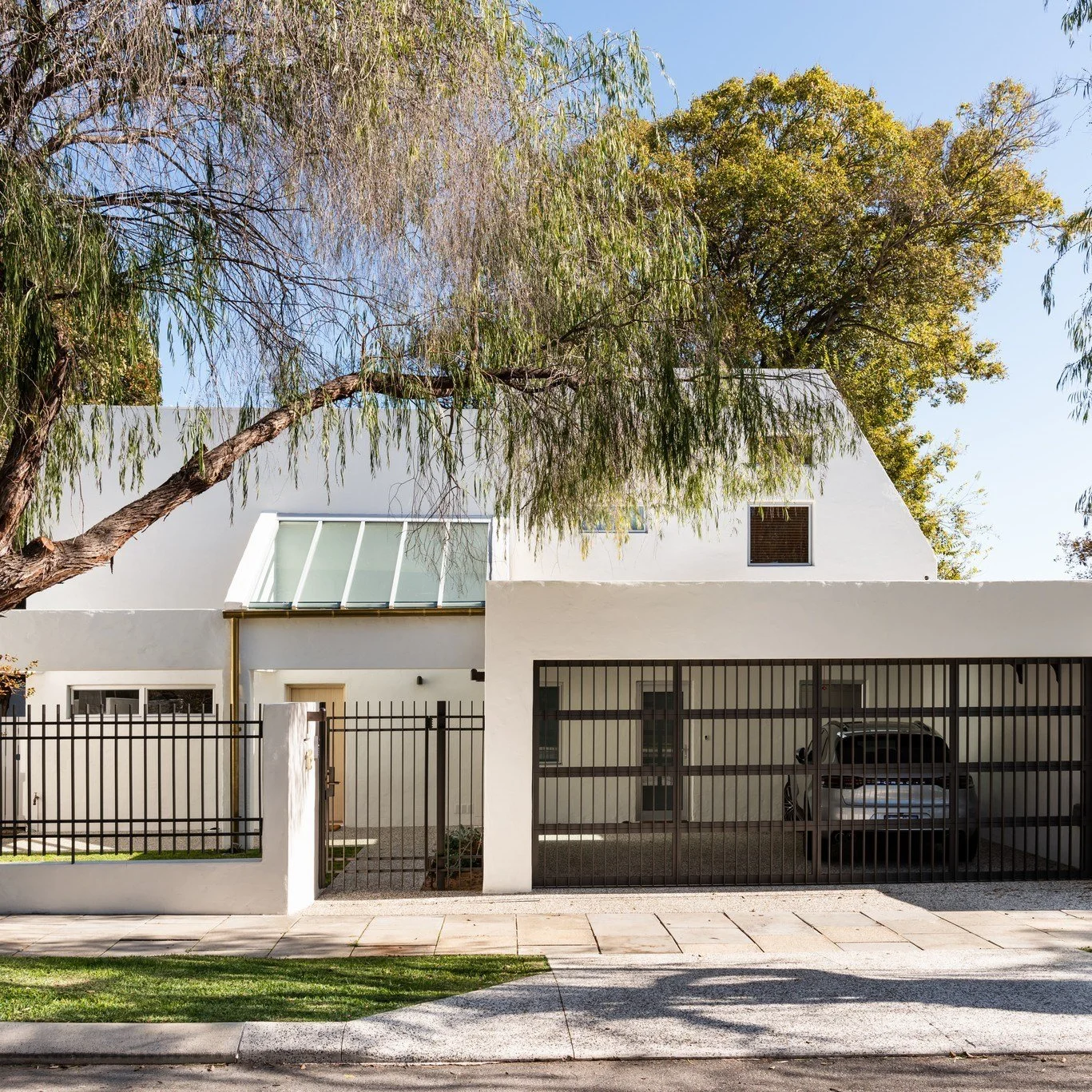 Imagine pulling up to this every afternoon. 🌿 Soft white walls glowing in the sun, a skylight entry that welcomes you home, and secure gates that look as good as they work.

Interior Design - @collectedinteriorsperth 
Front Door - @cedar_west 
Concr