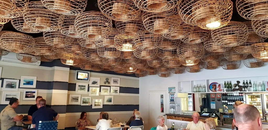 Traditional cane lobster traps used for ceiling cover and lighting together make an striking feature for any cafe, bar or restaurant.