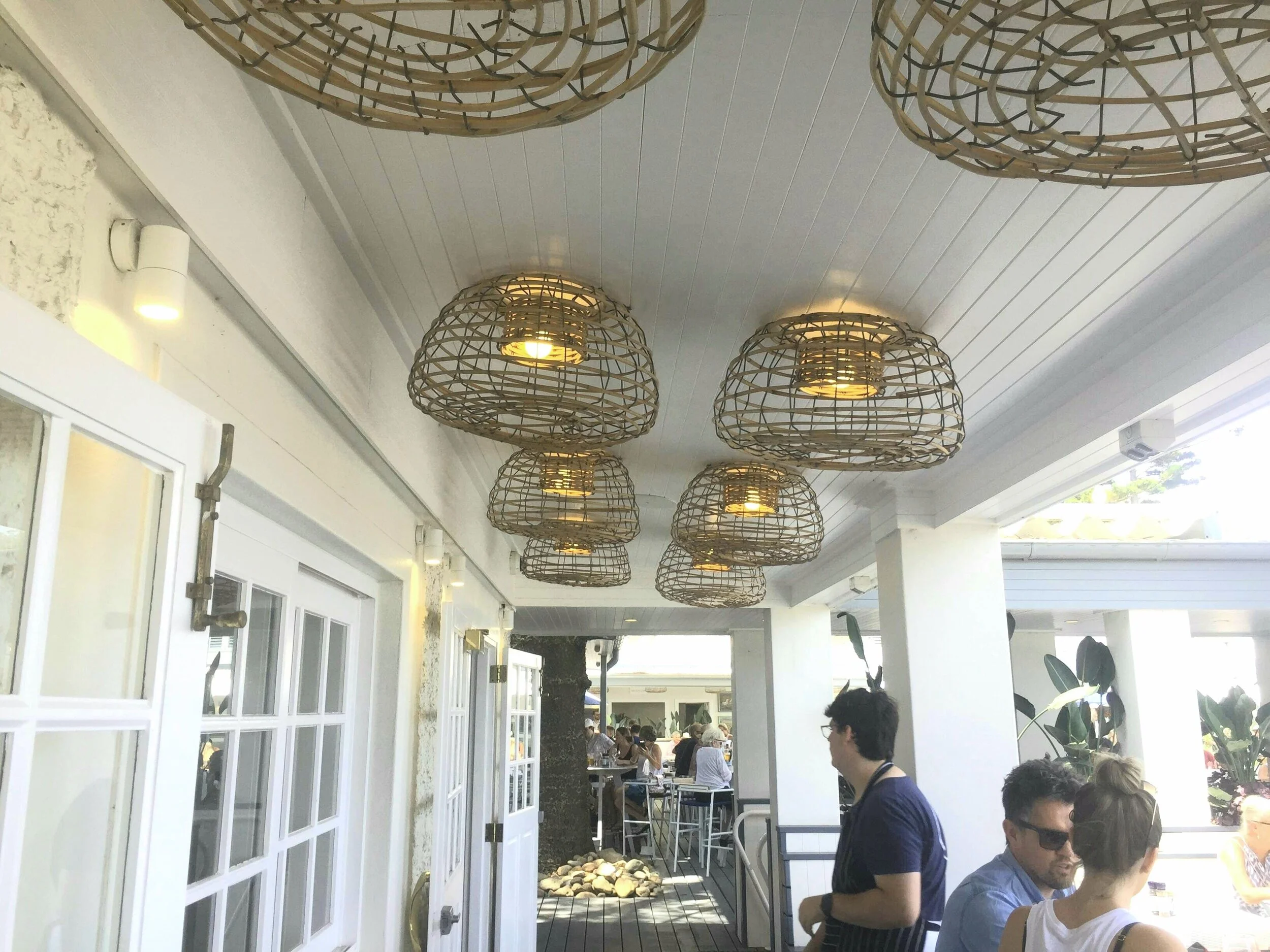 Ceiling lights using standard cane lobster pots for decor at Pertonga Beach, NSW.