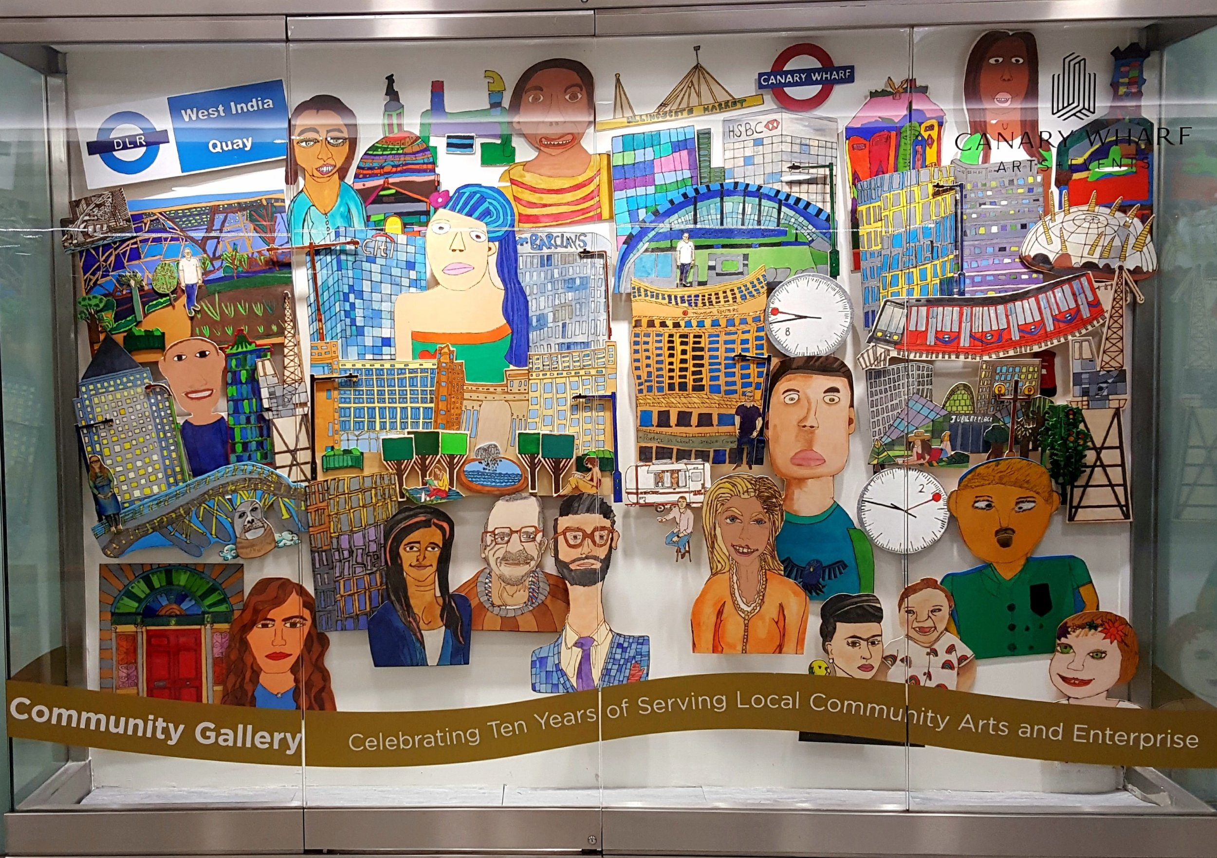   Community Window Exhibition at Canary Wharf, a mural depicting people and the buildings and landmarks of Canary Wharf. 