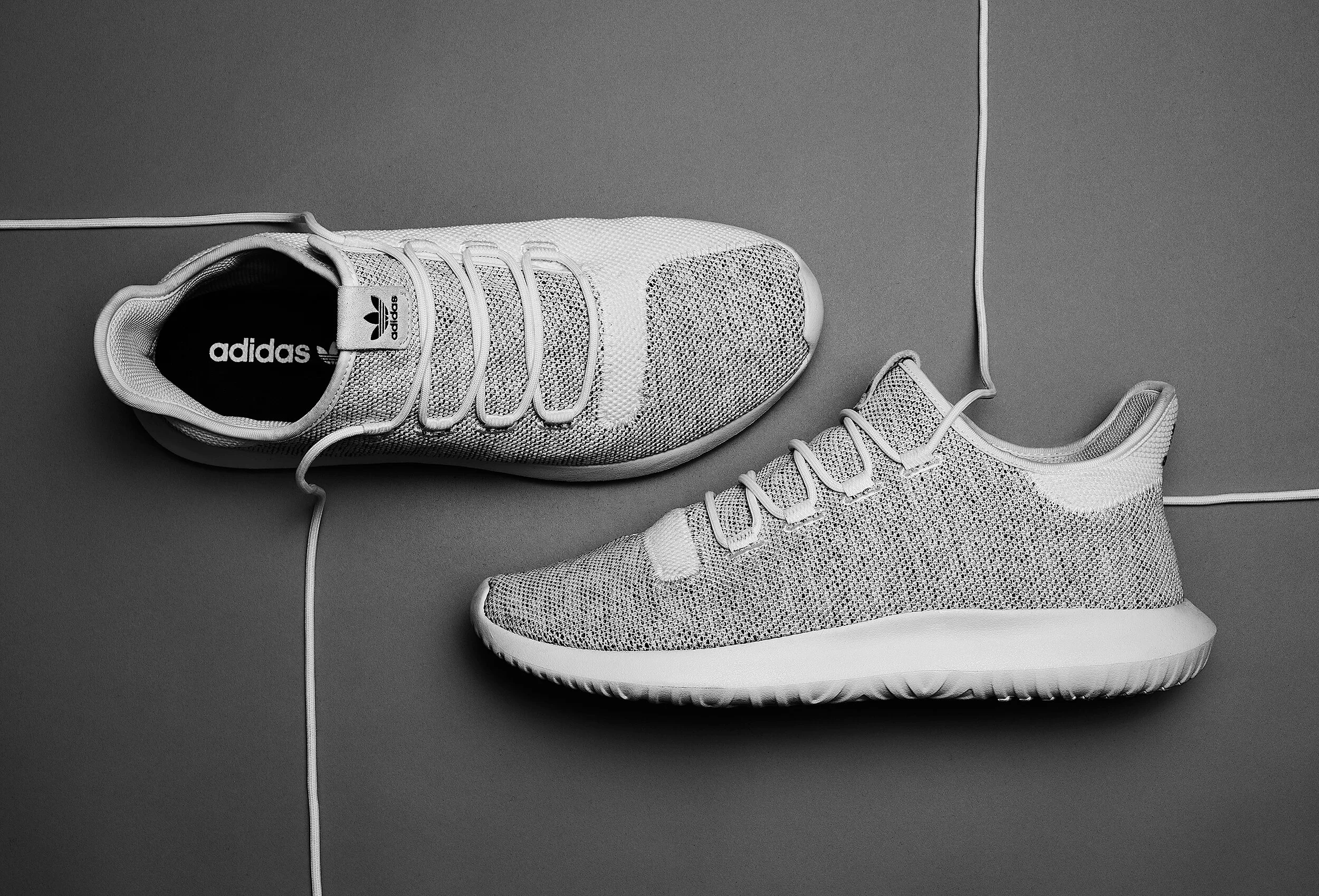 Adidas knit sneakers in gray on gray background