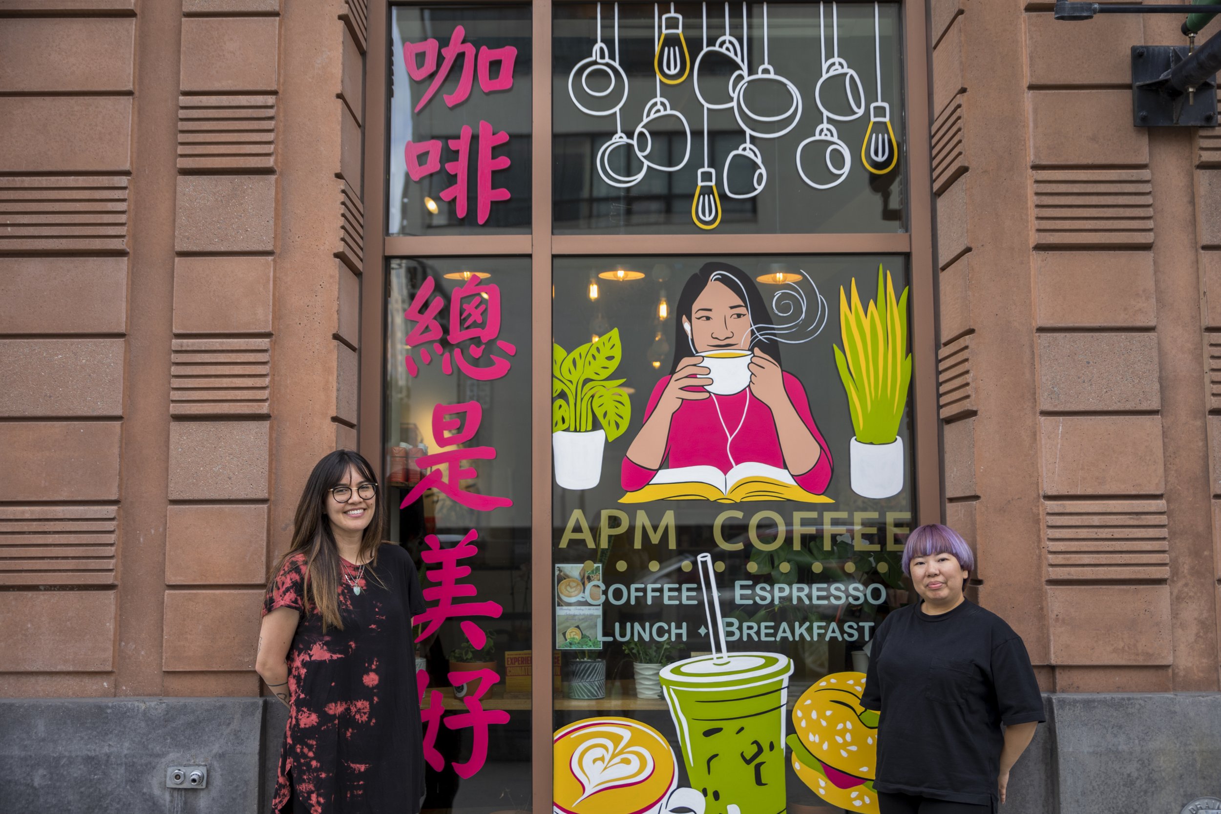 Amanda Beard Garcia in front of her mural, "Coffee is always beautiful," at APM Coffee with APM Coffee Co-Owner Alice Mei