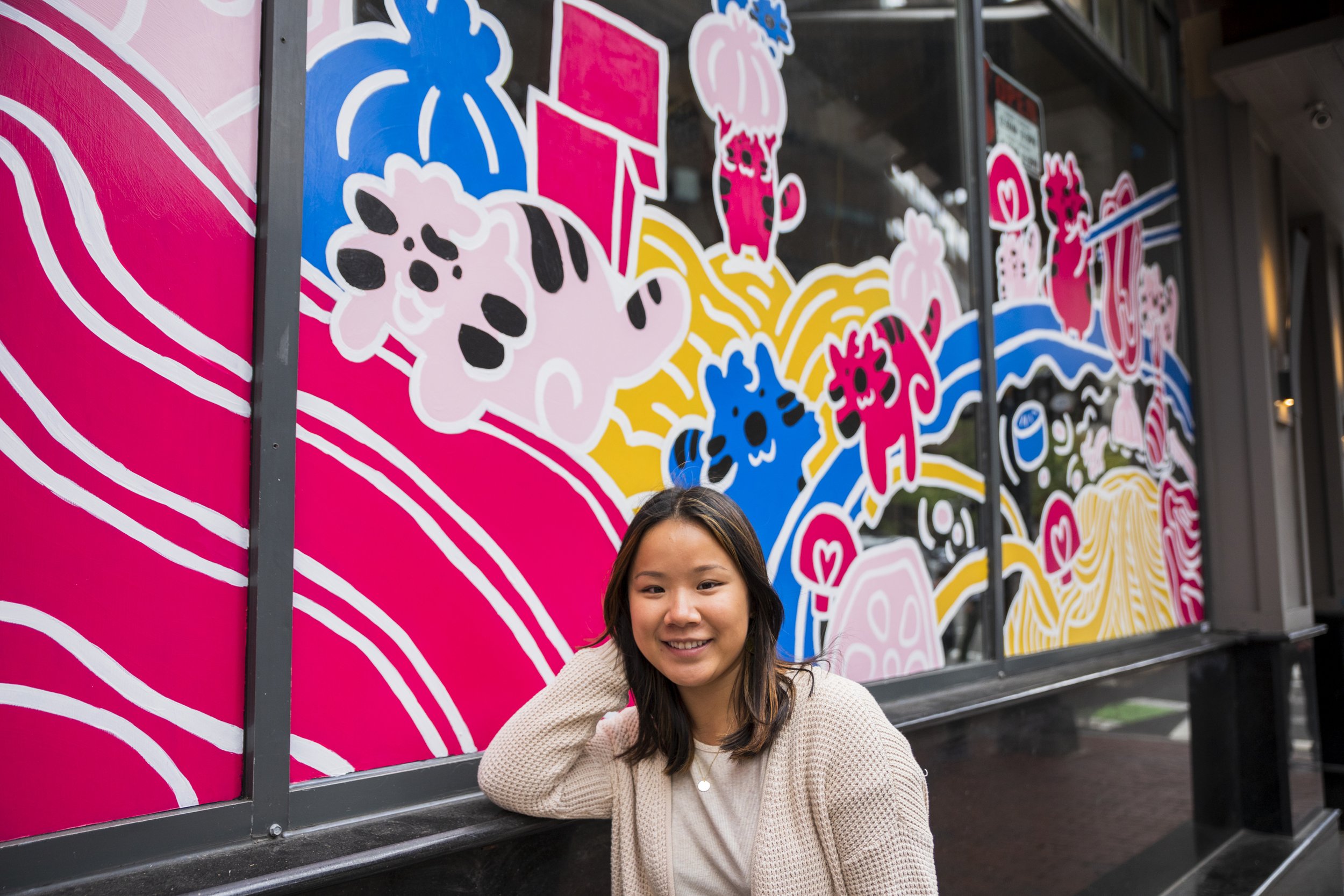 Nell Valle in front of her mural, "Tigers Hot Pot Together," at Liu Yi Shou Hot Pot