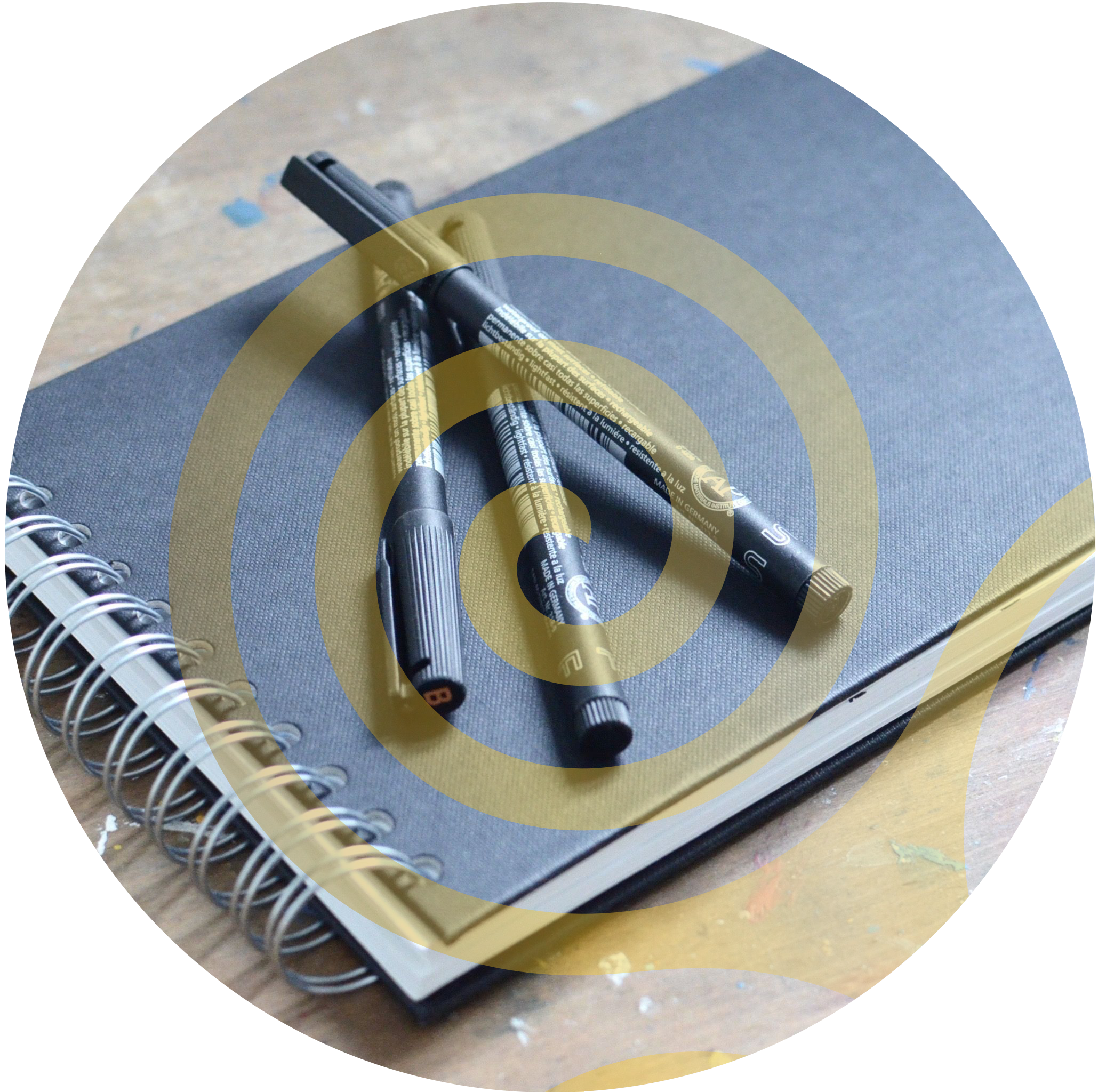 Closed sketchbook with pens for Kevin Maher.
