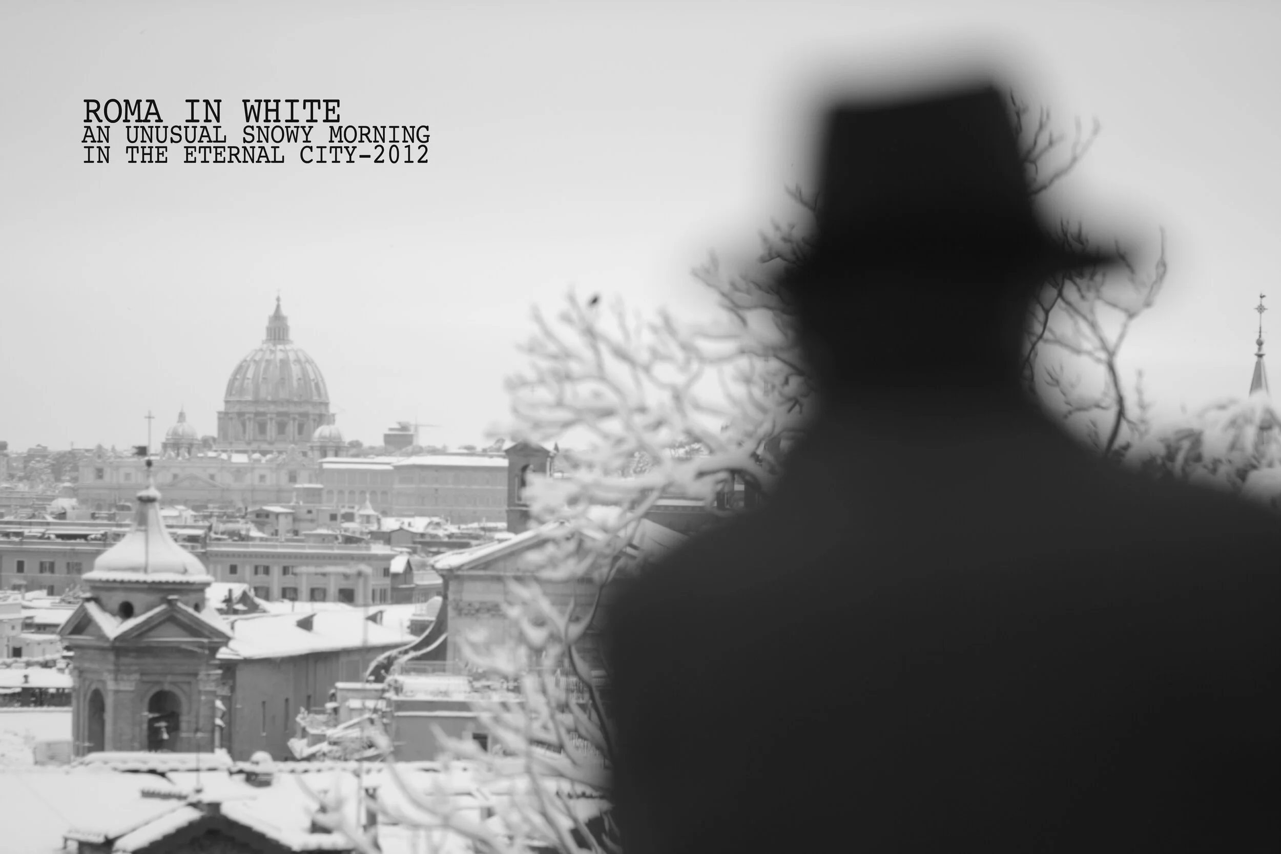 Blurry silhouette of a person with a hat, over a winter cityscape of Rome, including dome structures, under a snow-covered sky.