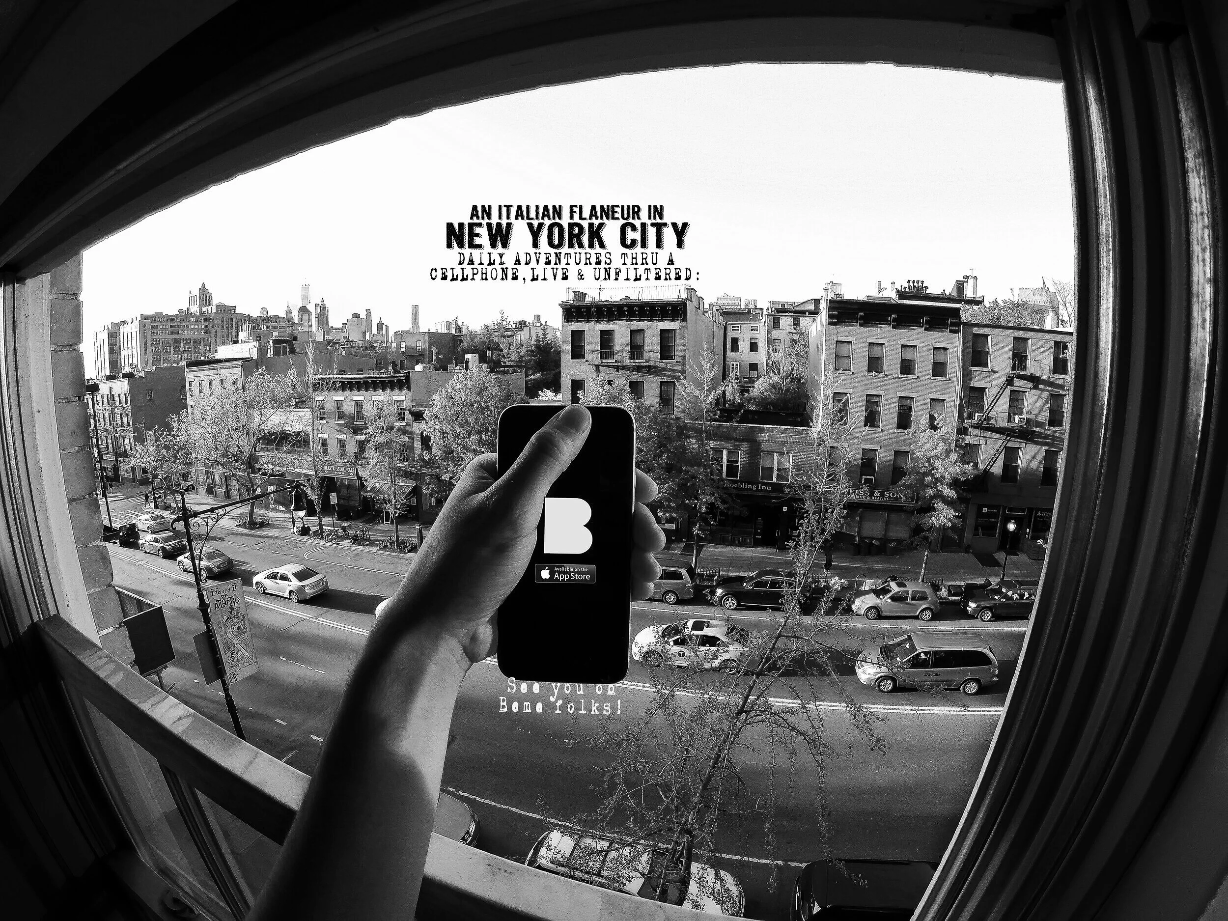 View through a window of a city street in New York City, with cars parked and buildings in the background. A person is holding a phone taking a selfie, with a sticker on the phone that says, "See You Bme Folks!" and a sticker below that shows availab