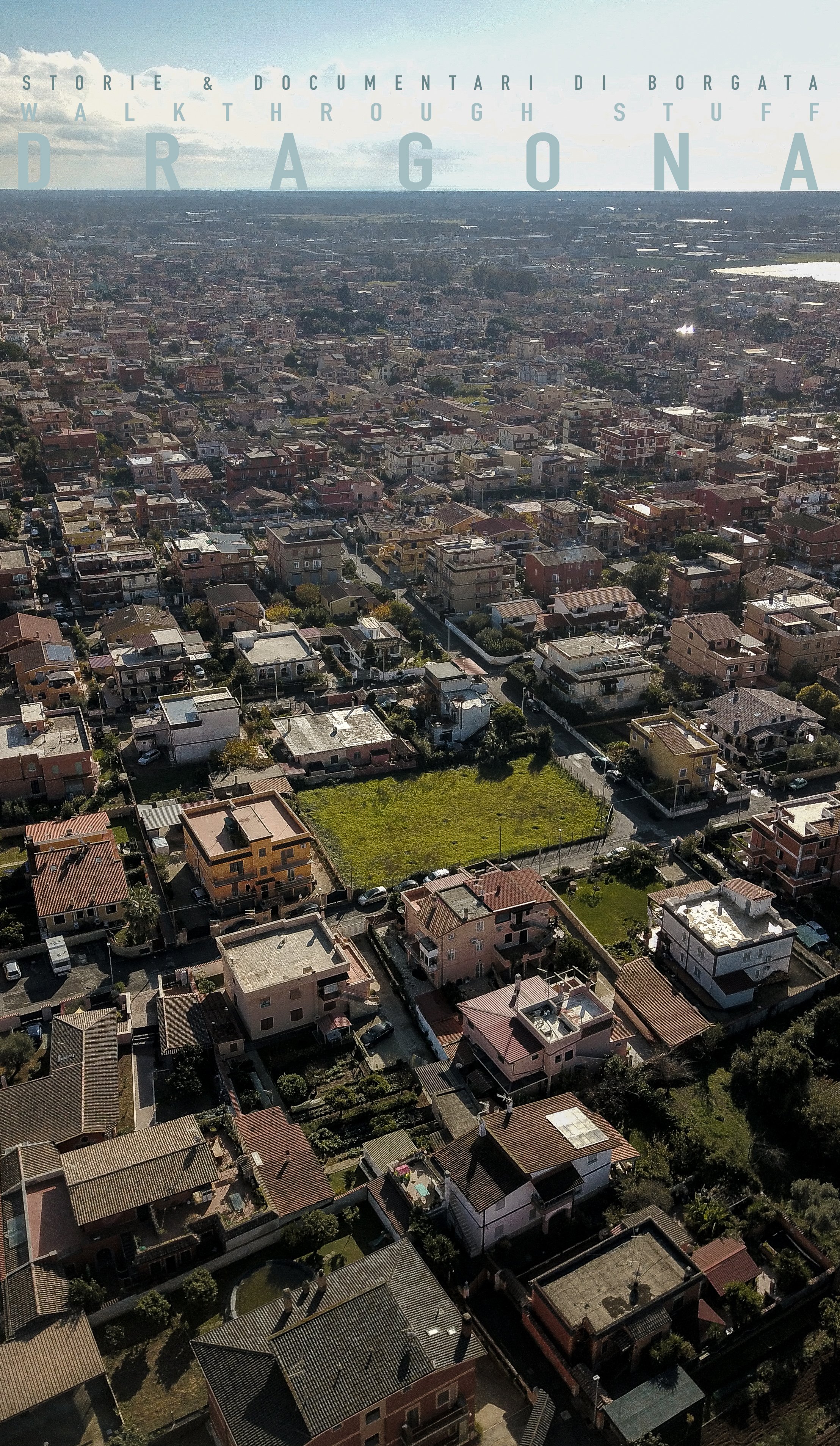 Aerial view of a residential neighborhood with houses, streets, and some green spaces under a partly cloudy sky.