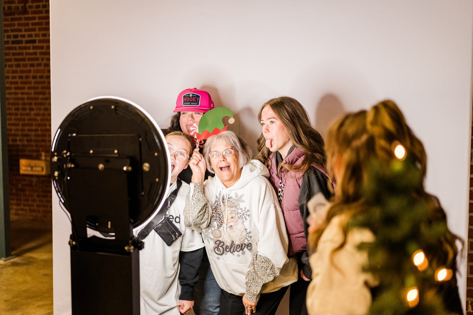 Friends and family having fun at the photo booth at the Illinois Local Holiday Market, a Small Business Saturday event in Springfield, IL