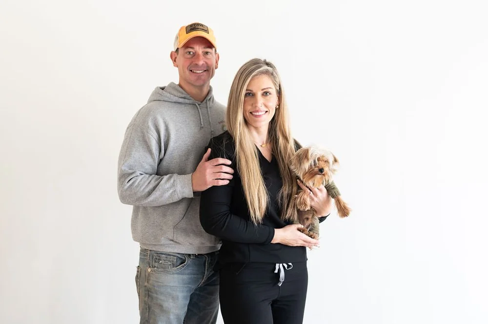 Two Illinois Local member business owners smiling together, one holding a small dog