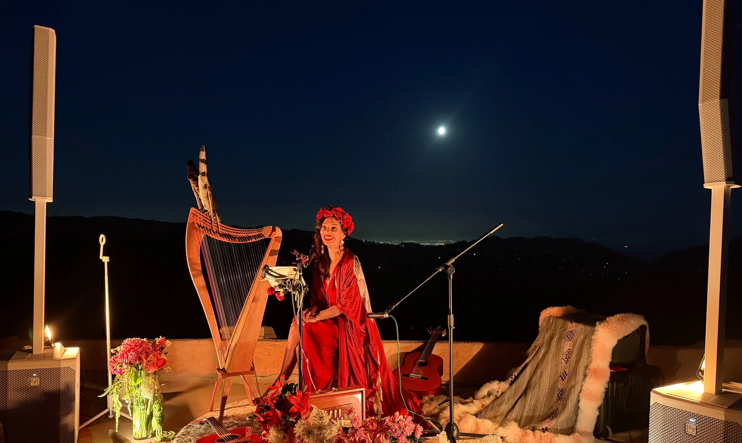 A private moon ceremony on the deck in Topanga, California, with harp, candles, and flowers beneath the full moon
